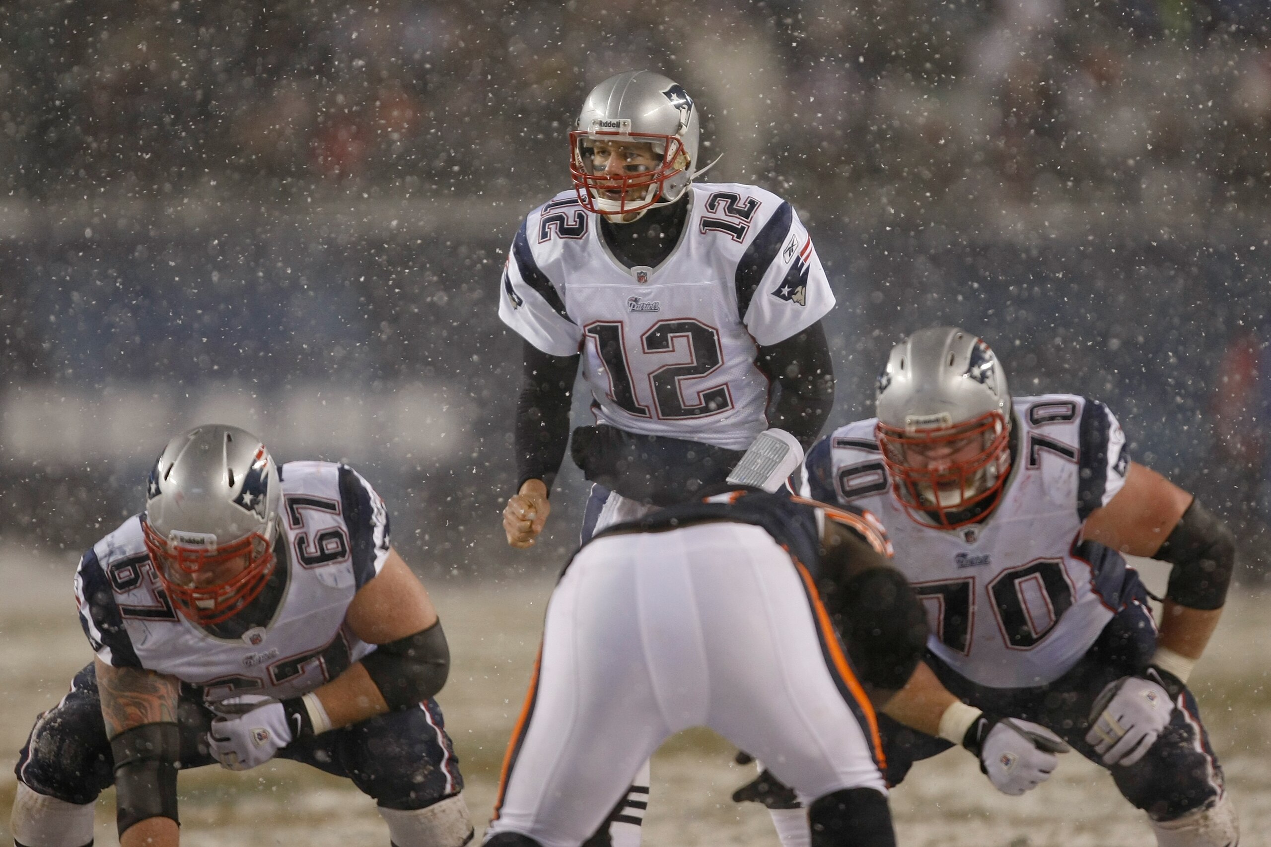 CHICAGO, IL - DECEMBER 12: Tom Brady #12 of the New England Patriots calls out signals as Dan Koppen #67 and Logan Mankins #70 awaits the snap against the Chicago Bears at Soldier Field on December 12, 2010 in Chicago, Illinois. The Patriots defeated the