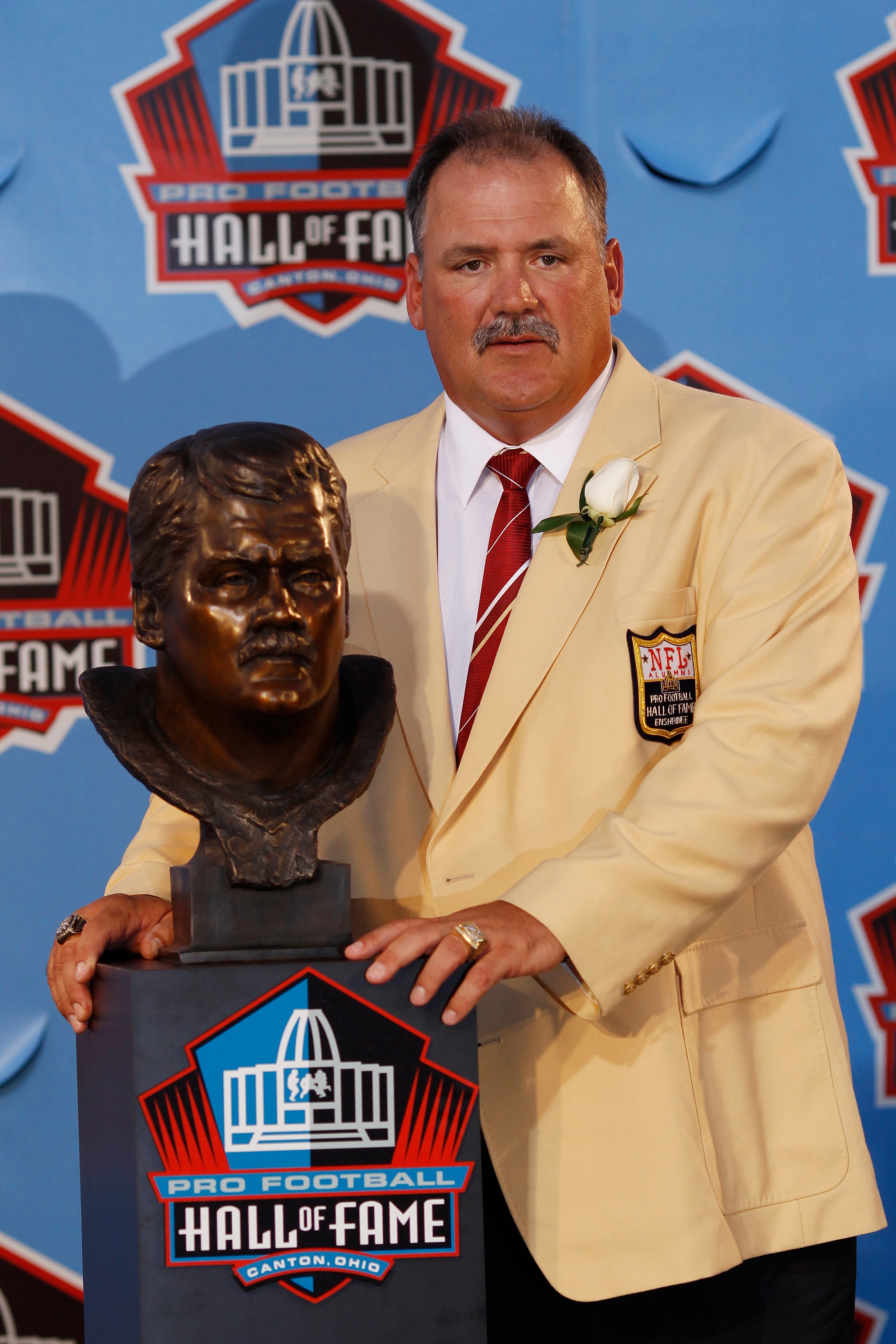 CANTON, OH - AUGUST 7: Russ Grimm poses with his bust during the 2010 Pro Football Hall of Fame Enshrinement Ceremony at the Pro Football Hall of Fame Field at Fawcett Stadium on August 7, 2010 in Canton, Ohio. (Photo by Joe Robbins/Getty Images)