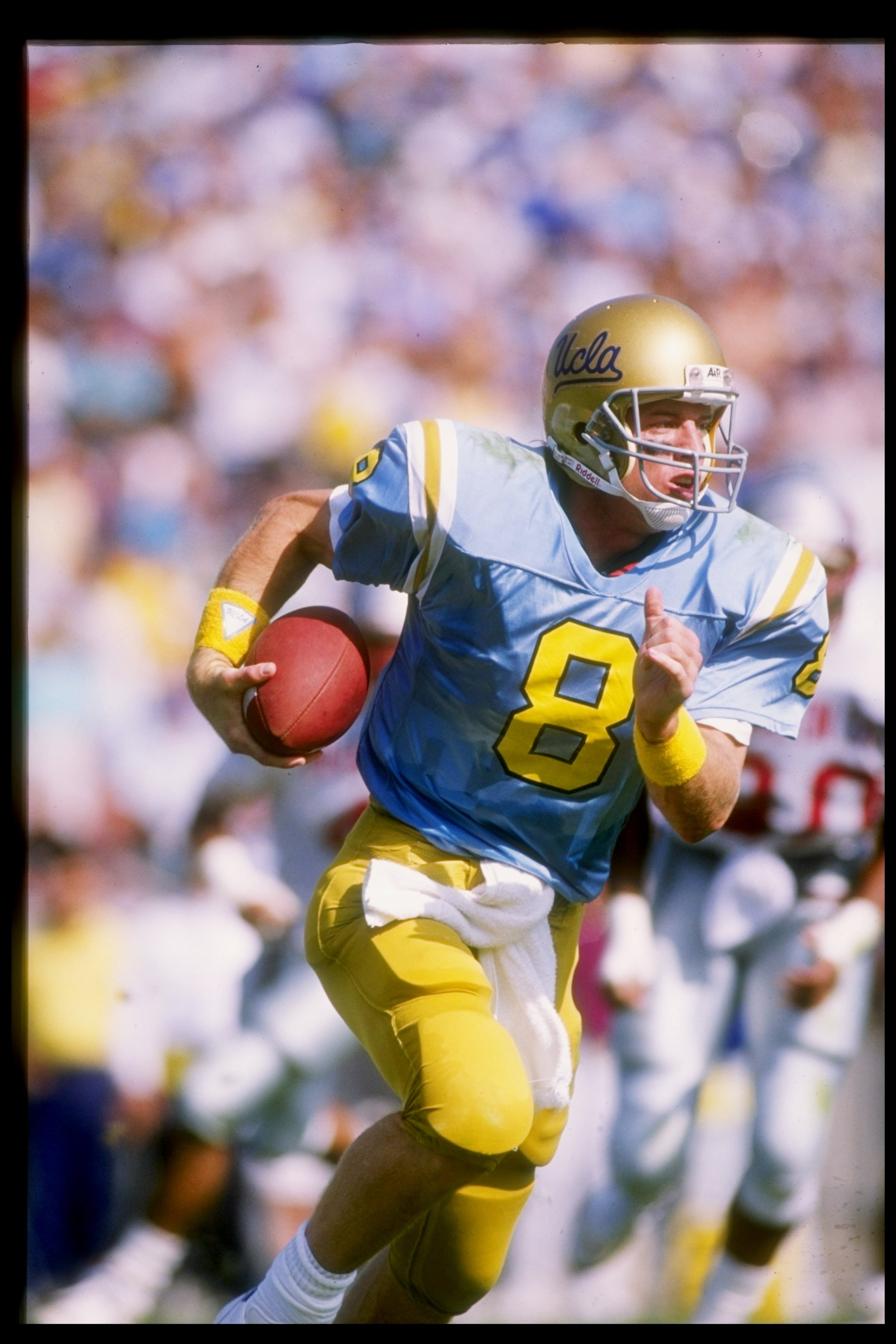 29 Oct 1988:  Quarterback Troy Aikman of the UCLA Bruins runs down the field during a game against the Washington State Cougars at the Rose Bowl in Pasadena, California.  Washington State won the game 34-30. Mandatory Credit: Mike Powell  /Allsport