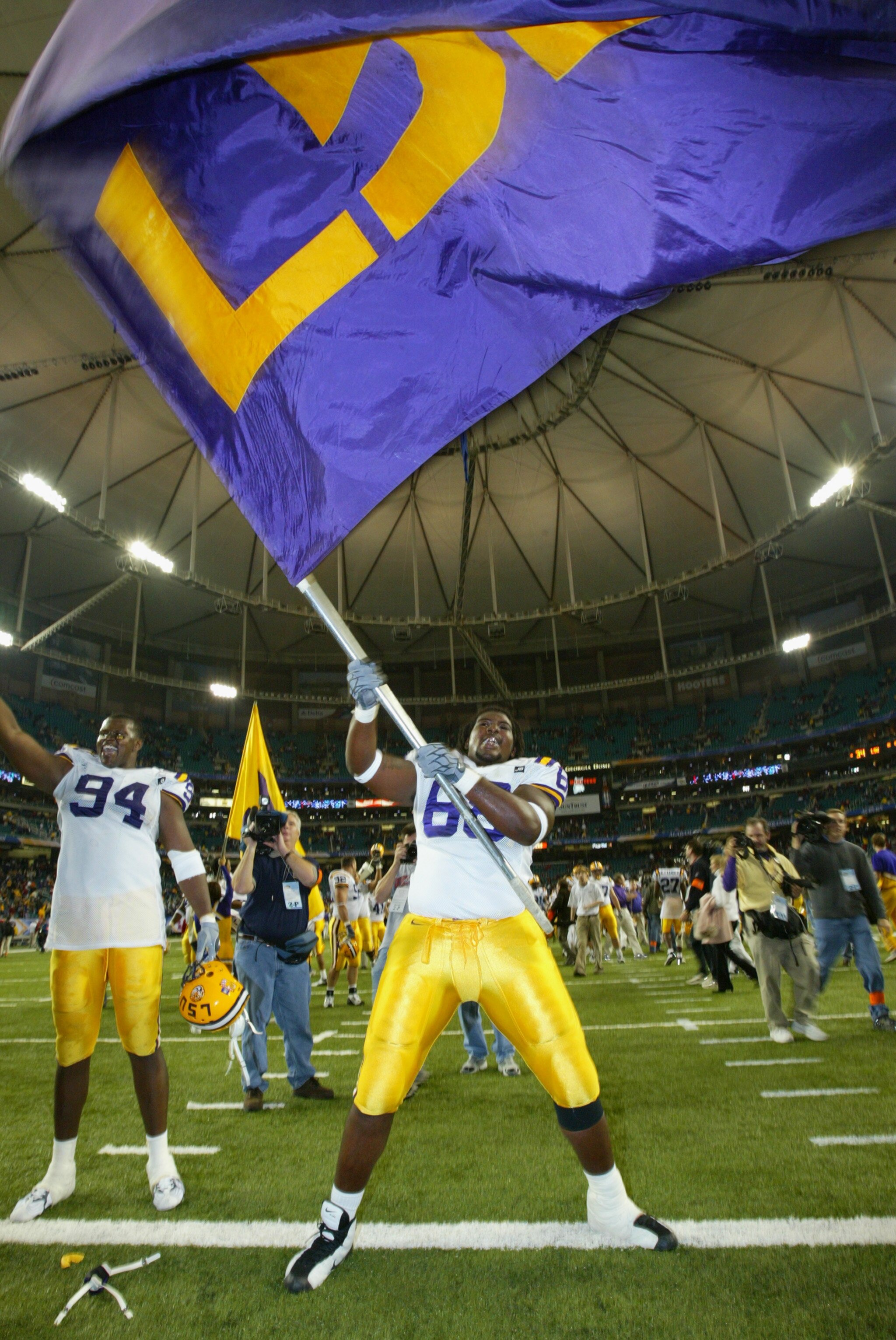 ATLANTA, GA - DECEMBER 6:  Offensive guard Terrell McGill #68 of the LSU Tigers waives the team flag after the game against the Georgia Bulldogs inthe SEC Championship Game on December 6, 2003 at the Georgia Dome in Atlanta, Georgia. LSU defeated Georgia
