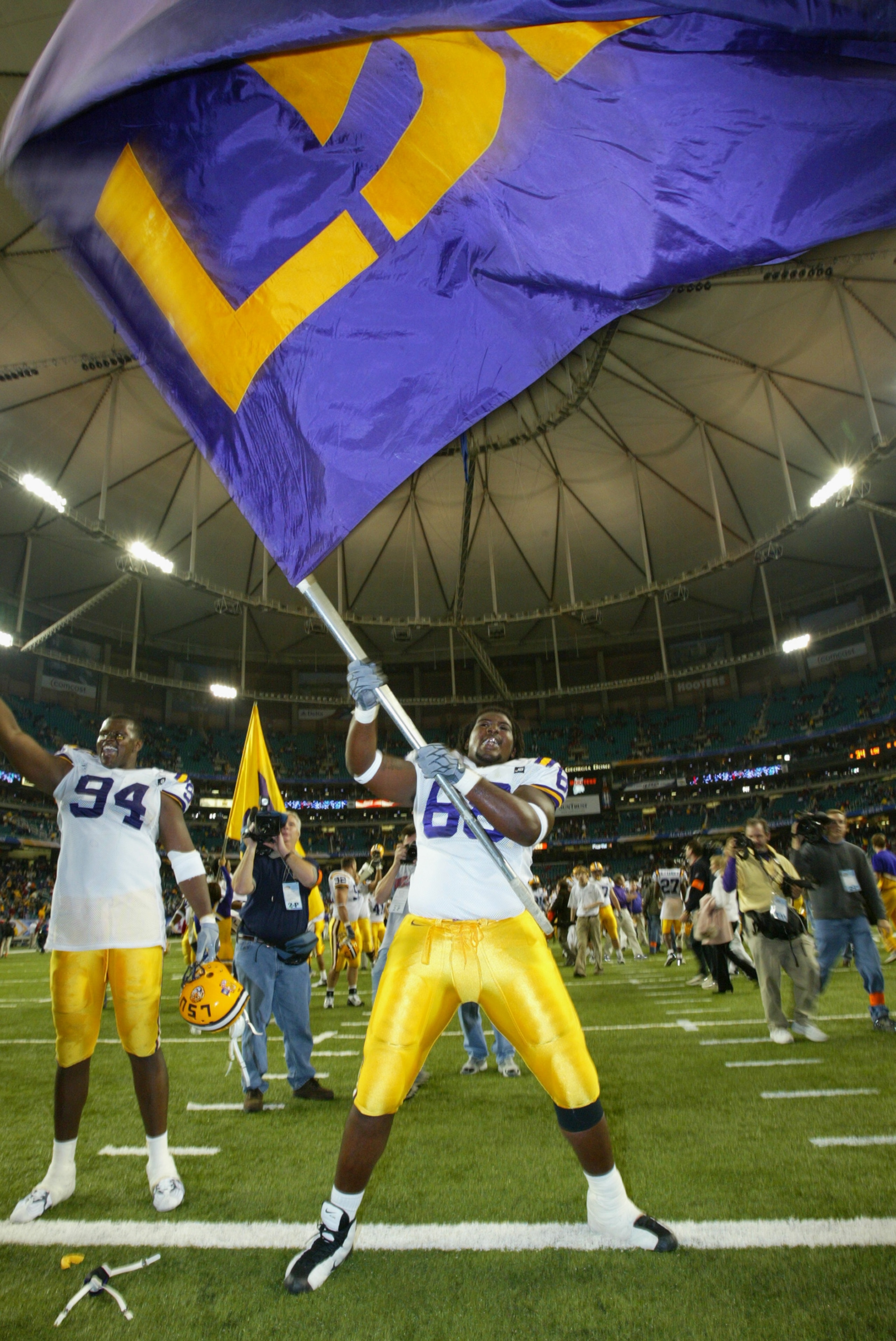 ATLANTA, GA - DECEMBER 6:  Offensive guard Terrell McGill #68 of the LSU Tigers waives the team flag after the game against the Georgia Bulldogs inthe SEC Championship Game on December 6, 2003 at the Georgia Dome in Atlanta, Georgia. LSU defeated Georgia