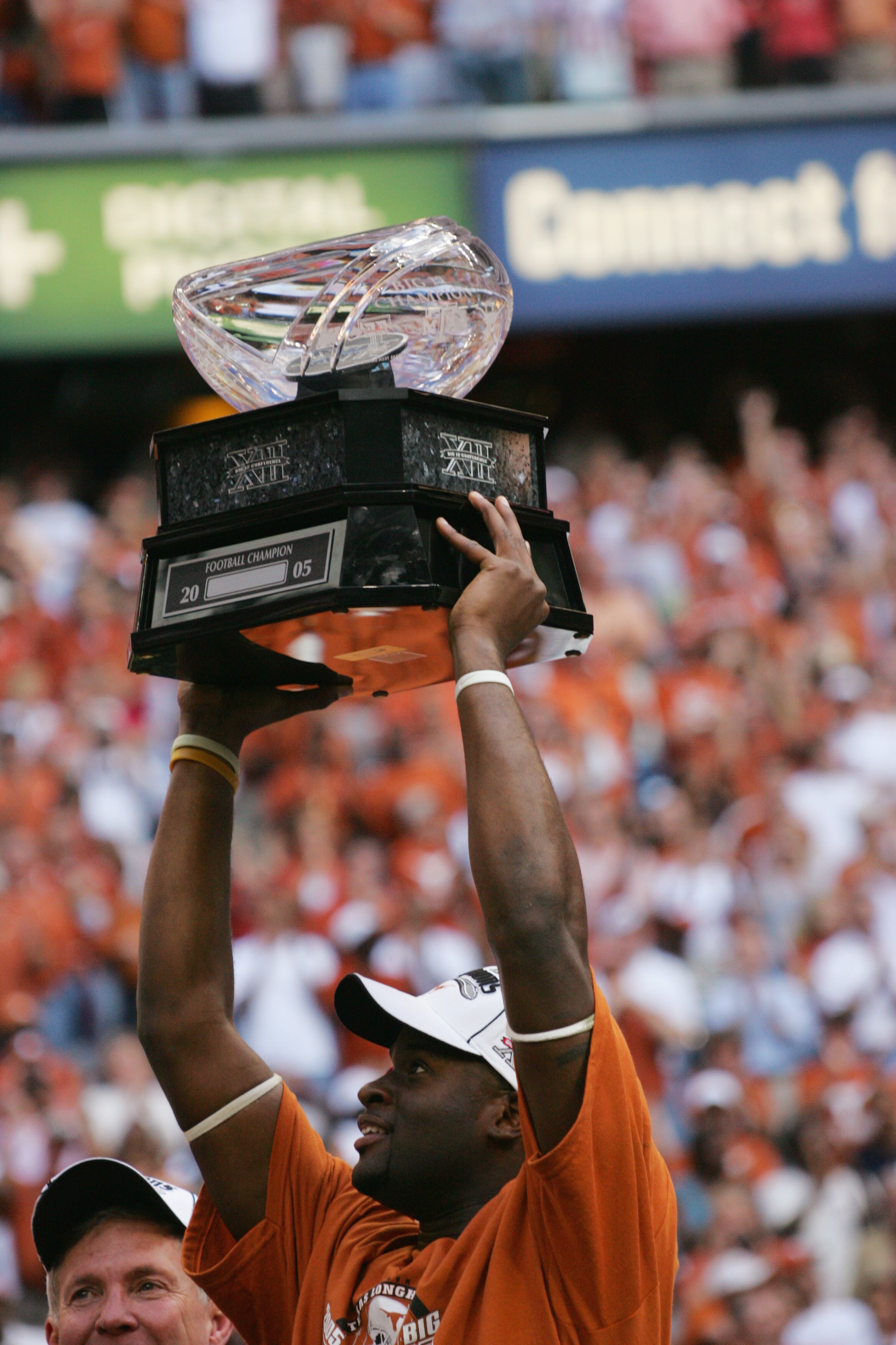 HOUSTON - DECEMBER 3:  Quarterback Vince Young #10 of the Texas Longhorns holds up the trophy following the Dr. Pepper Big 12 Championship against the Colorado Buffaloes at Reliant Stadium on December 3, 2005  in Houston, Texas. The Longhorns defeated the