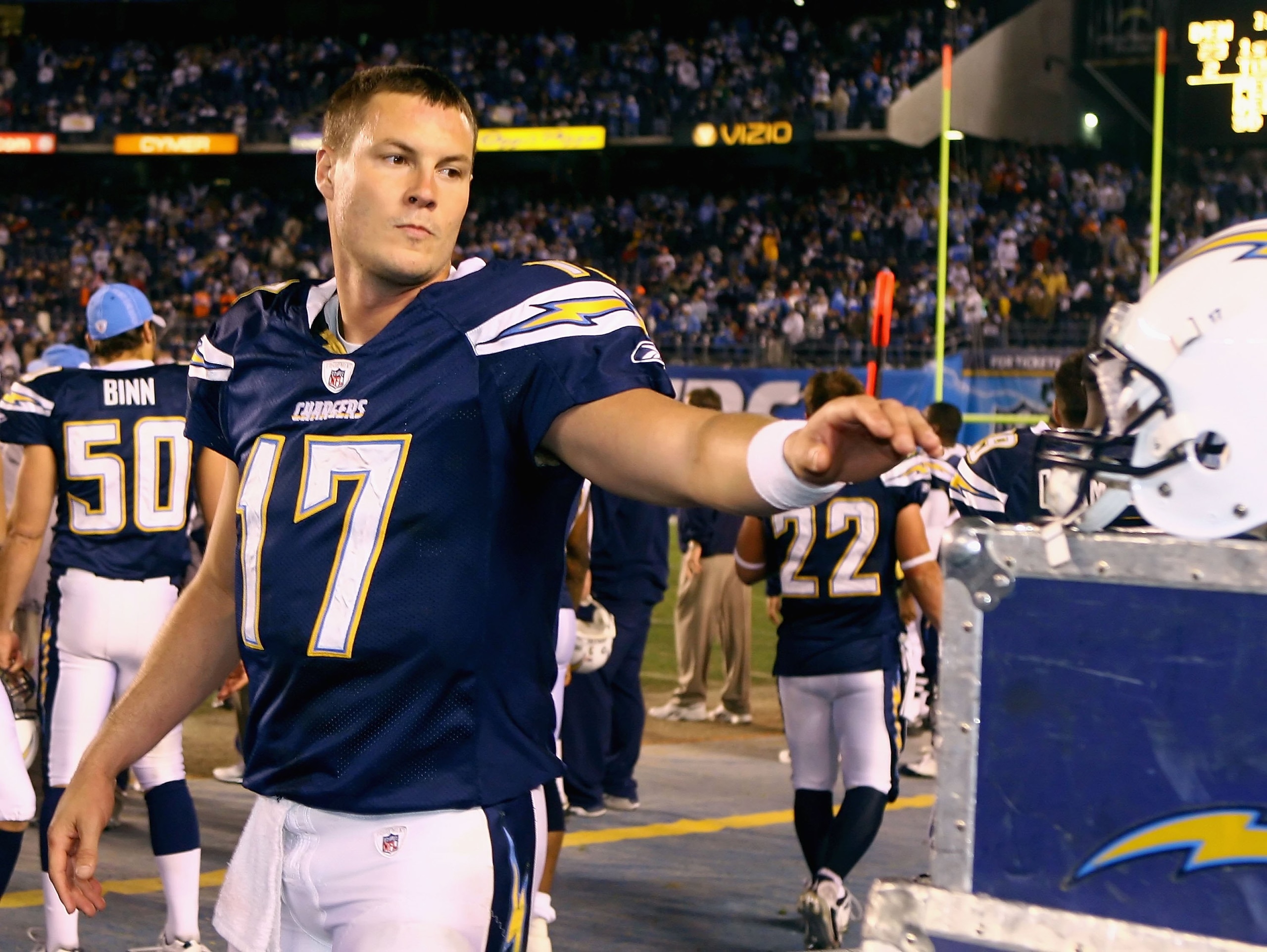 SAN DIEGO - DECEMBER 28:  Quarterback Philip Rivers #17 of the San Diego Chargers reaches for his helmet during the NFL game against the Denver Broncos at Qualcomm Stadium on December 28, 2008 in San Diego, California.  The Chargers defeated the Broncos 5