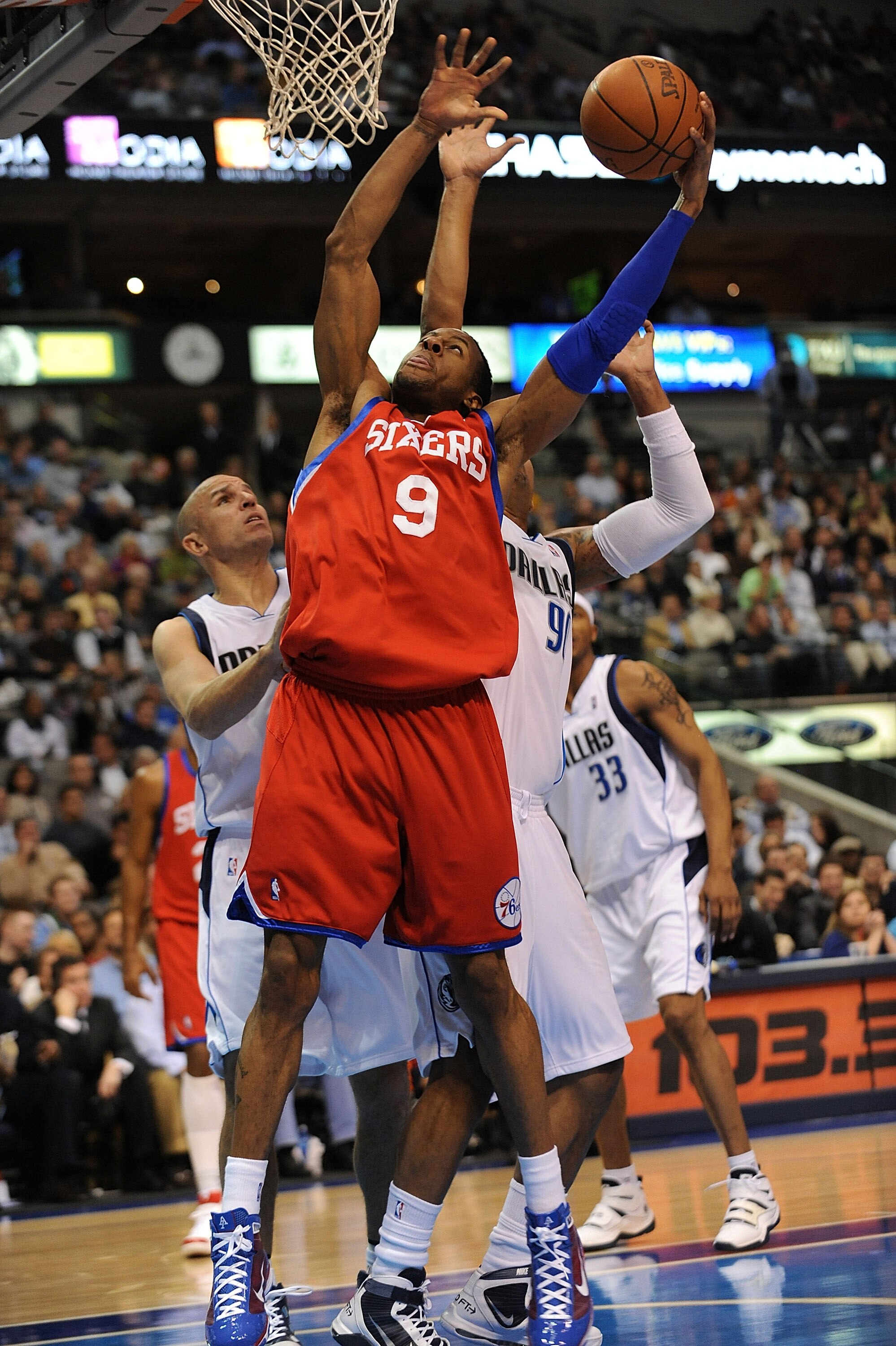 DALLAS - NOVEMBER 30:  Guard Andre Iguodala #9 of the Philadelphia 76ers takes a shot against Jason Kidd #0 of the Dallas Mavericks on November 30, 2009 at American Airlines Center in Dallas, Texas.  NOTE TO USER: User expressly acknowledges and agrees th