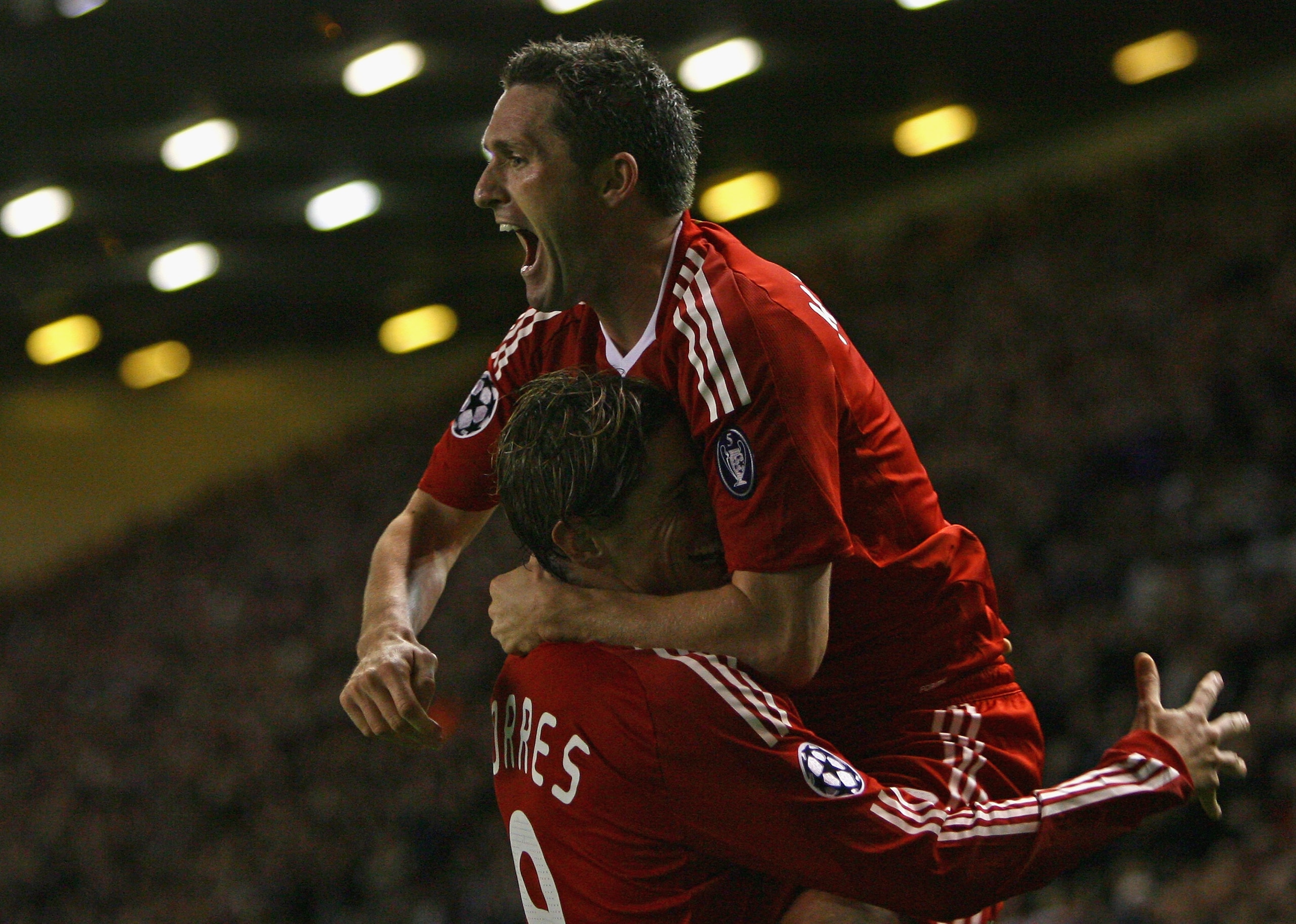 LIVERPOOL, UNITED KINGDOM - OCTOBER 01:  Robbie Keane of Liverpool celebrates scoring his team's second goal with team mate Fernando Torres during the UEFA Champions League Group D match between Liverpool and PSV Eindhoven at Anfield on October 1, 2008 in