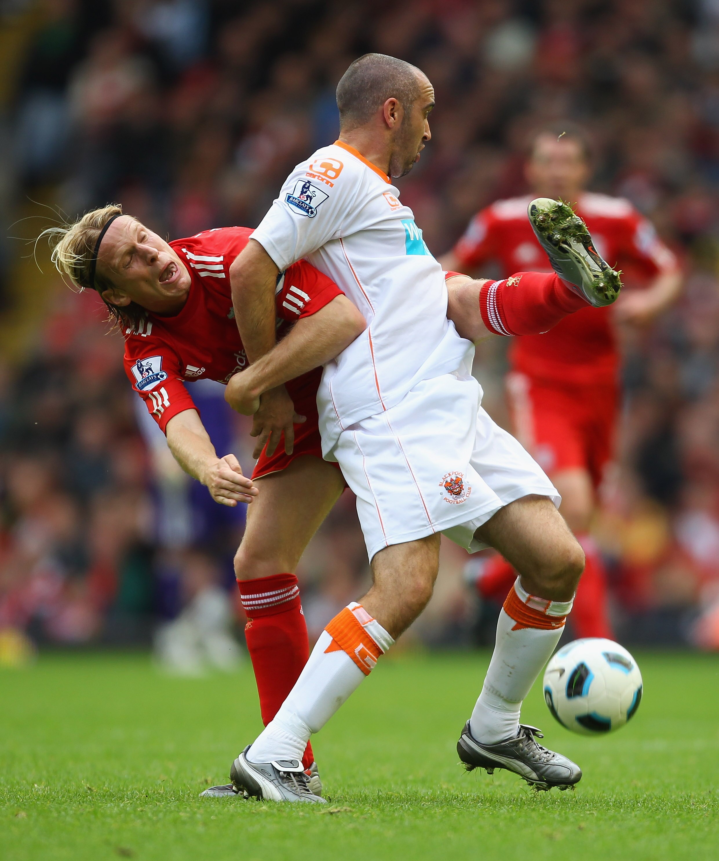 LIVERPOOL, ENGLAND - OCTOBER 03:  Gary Taylor-Fletcher of Blackpool holds off a challenge from Christian Poulsen during the Barclays Premier League match between Liverpool and Blackpool at Anfield on October 3, 2010 in Liverpool, England.  (Photo by Alex