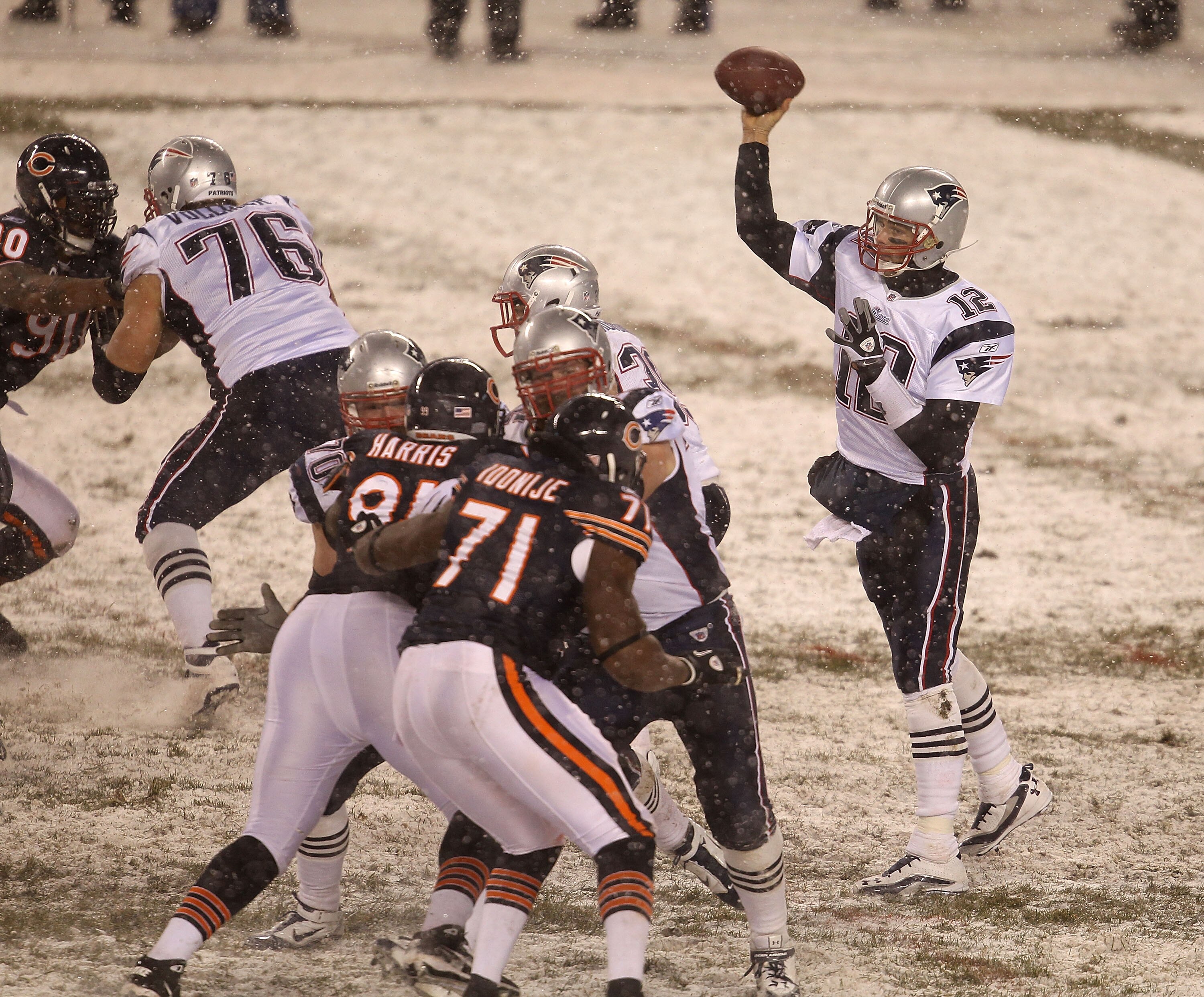 CHICAGO, IL - DECEMBER 12: Tom Brady #12 of the New England Patriots throws a pass as Tommie Harris #91 and Israel Idonije #71 of the Chicago Bears rush at Soldier Field on December 12, 2010 in Chicago, Illinois. The Patriots defeated the Bears 36-7. (Pho