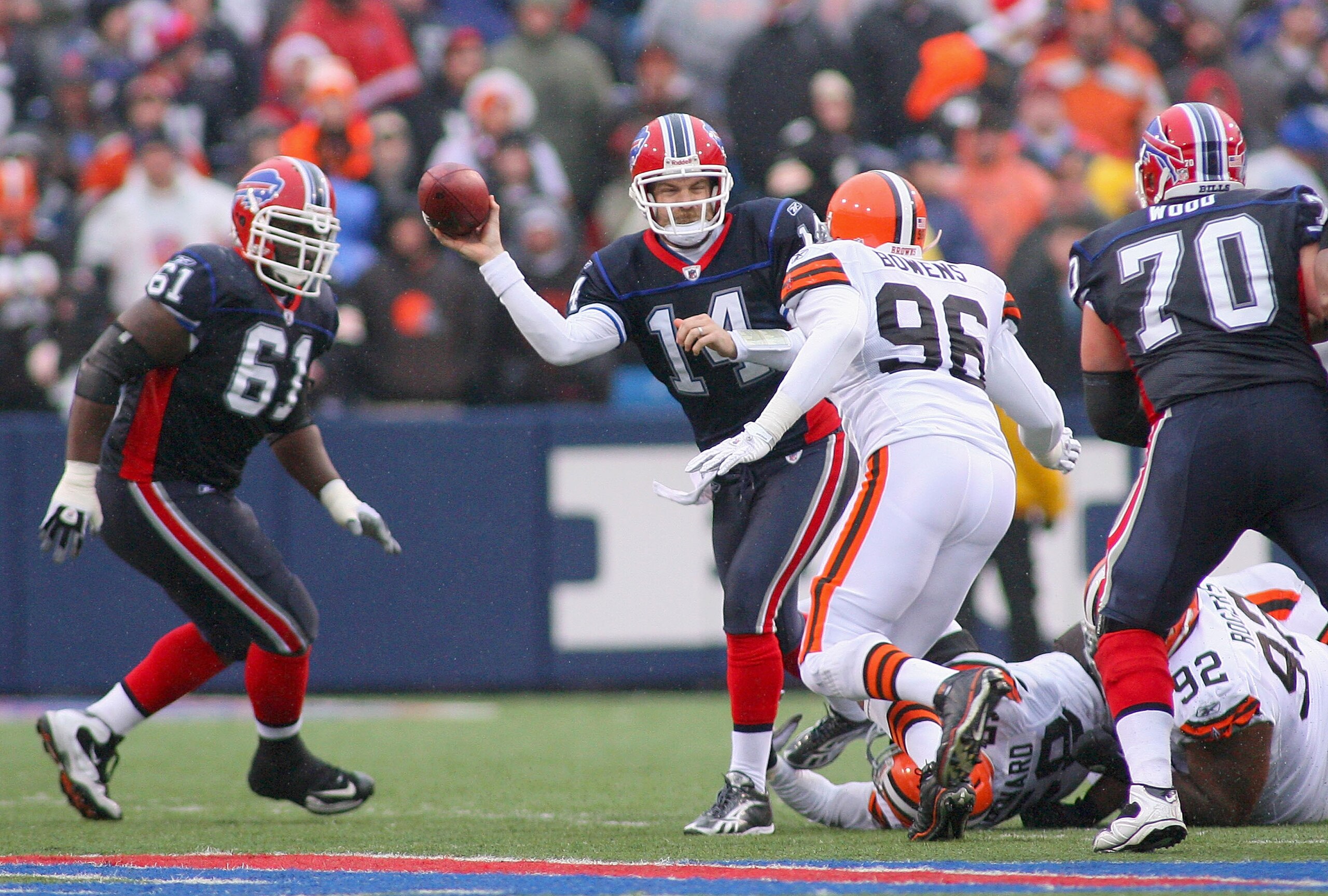 ORCHARD PARK, NY - DECEMBER 12:  Ryan Fitzpatrick #14 of the Buffalo Bills looks to pass with pressure from David Bowens #96 of the Cleveland Browns at Ralph Wilson Stadium on December 12, 2010 in Orchard Park, New York. Buffalo won 13-6.  (Photo by Rick