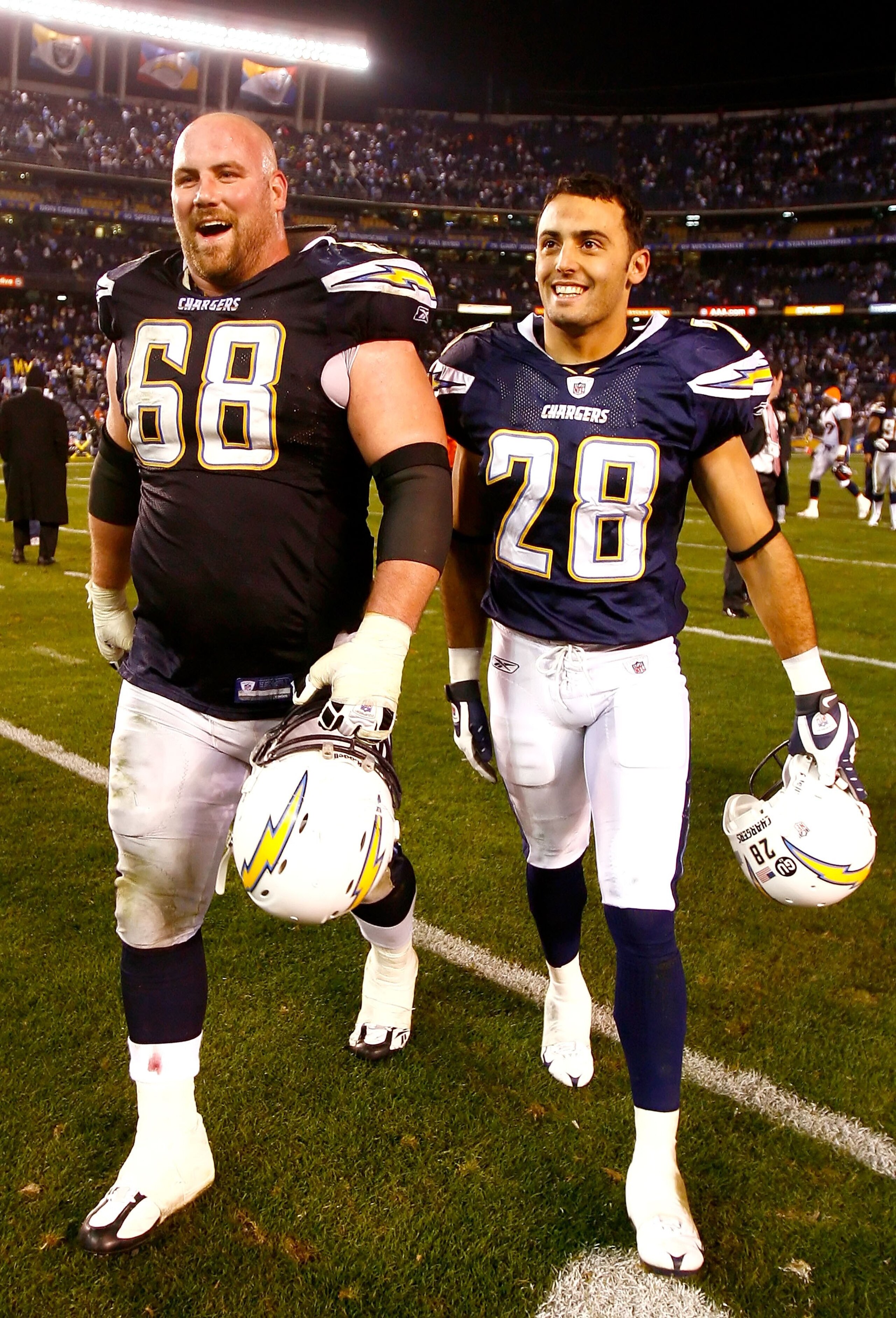 SAN DIEGO - DECEMBER 28:  Kris Dielman #68 and Steve Gregory #28 of the San Diego Chargers celebrate as they walk off the field after defeating the Denver Broncos in the NFL game at Qualcomm Stadium on December 28, 2008 in San Diego, California. The Charg