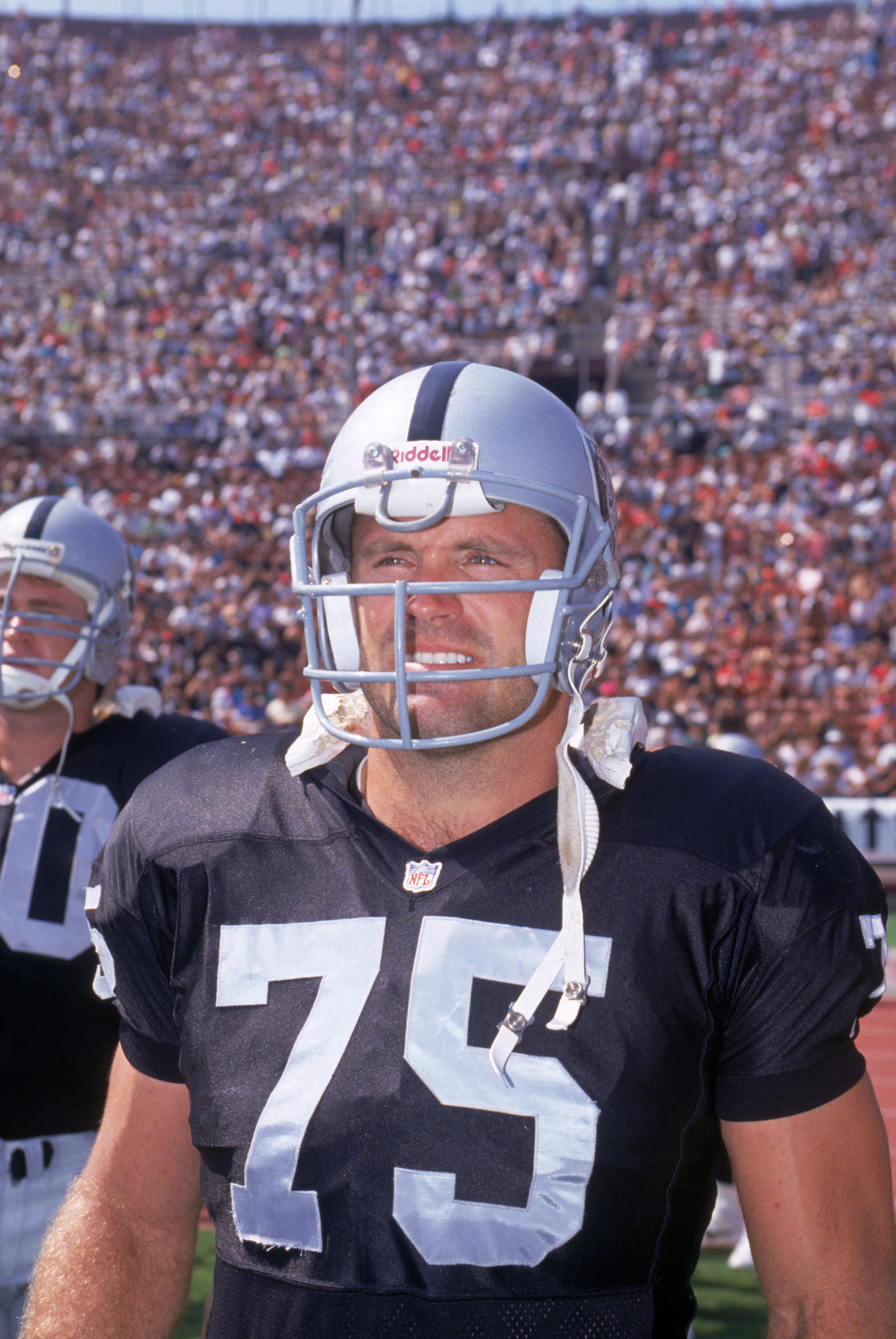 LOS ANGELES - SEPTEMBER 29:  Defensive lineman Howie Long #75 of the Los Angeles Raiders looks on as he stand on the sideline during a game against the San Francisco 49ers at Los Angeles Memorial Coliseum on December 29, 1991 in Los Angeles, California.