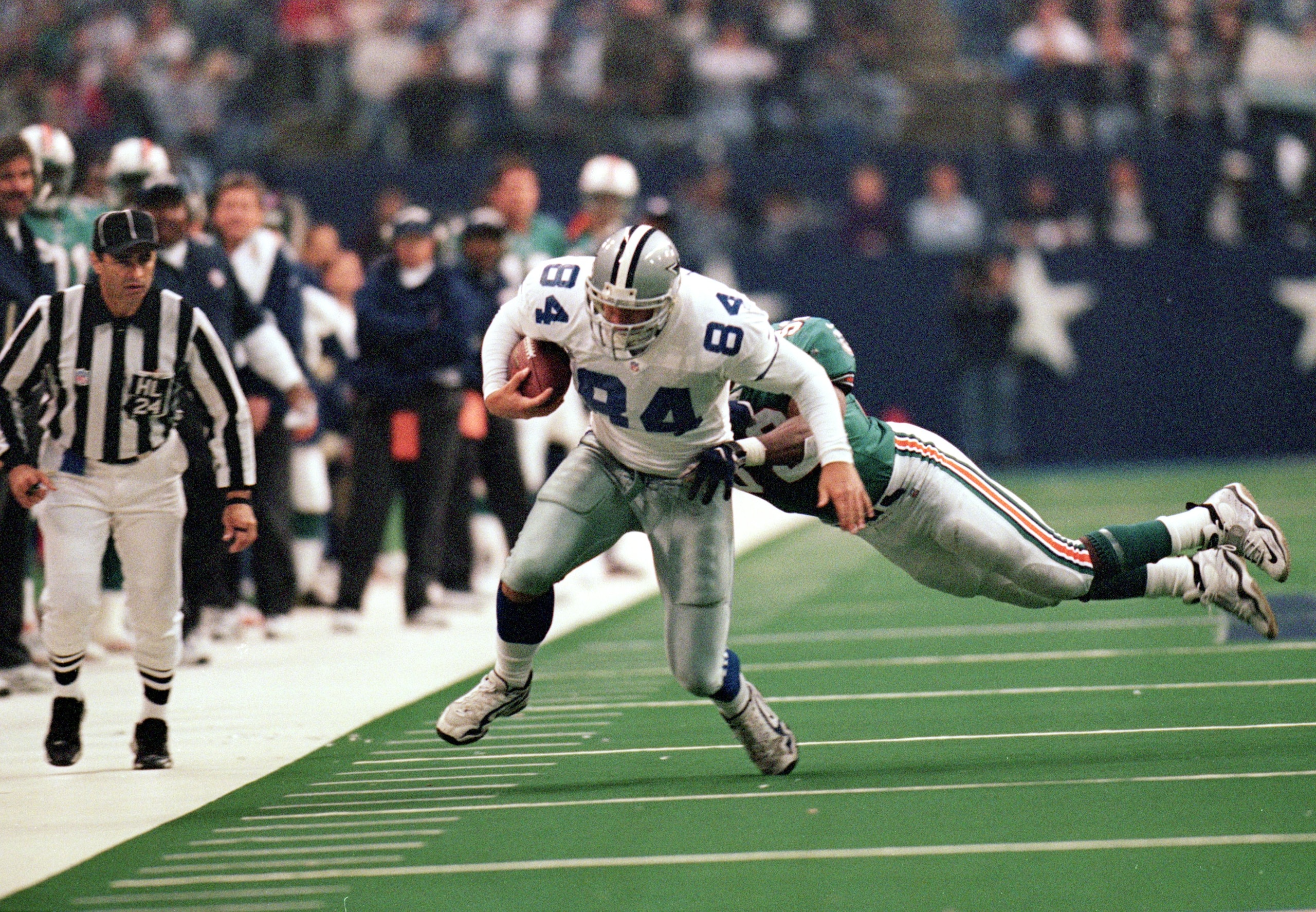 25 Nov 1999: Michael Lucky #84 of the Dallas Cowboys carries the ball as he is tackled during the game against the Miami Dolphins at the Texas Stadium in Irving, Texas. The Cowboys defeated the Dolphins 20-3. Mandatory Credit: Ronald Martinez  /Allsport