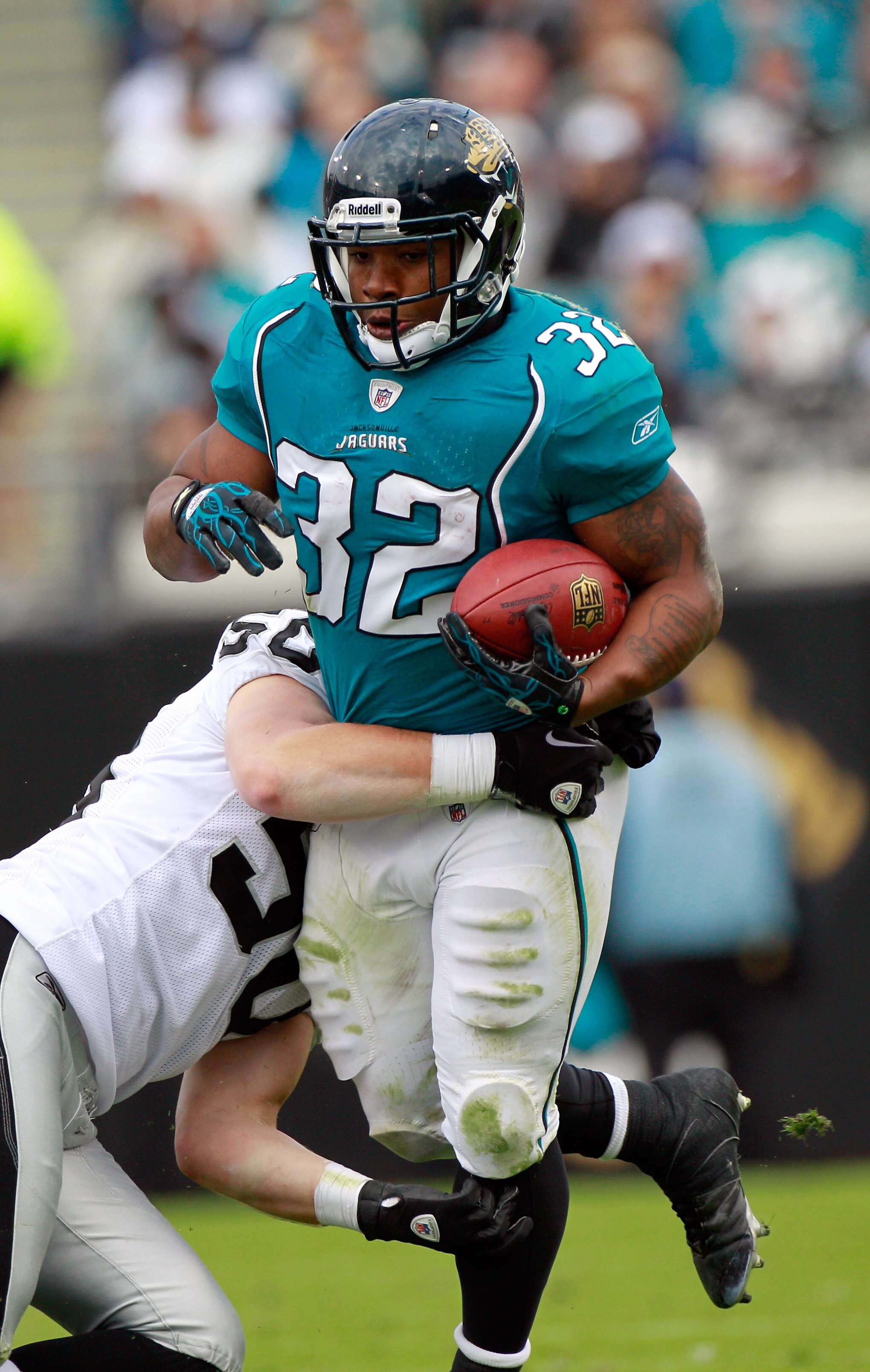 JACKSONVILLE, FL - DECEMBER 12:  Maurice Jones-Drew #32 of the Jacksonville Jaguars breaks the tackle of Travis Goethel #50 of the Oakland Raiders during the game at EverBank Field on December 12, 2010 in Jacksonville, Florida.  (Photo by Sam Greenwood/Ge