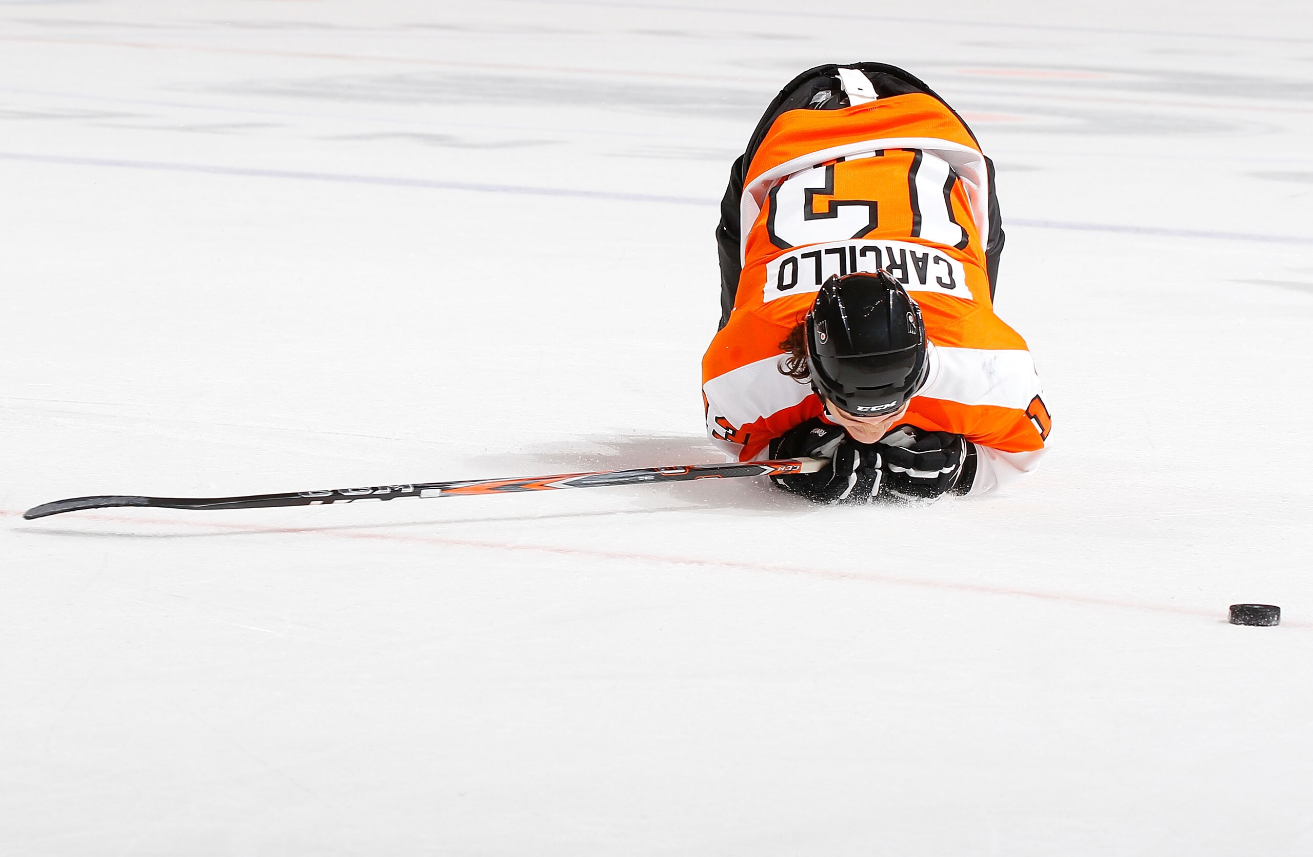 PHILADELPHIA - NOVEMBER 01:  Daniel Carcillo #13 of the Philadelphia Flyers falls to the ice after blocking a shot against the Carolina Hurricanes on November 1, 2010 at the Wells Fargo Center in Philadelphia, Pennsylvania. Flyers defeat the Hurricanes 3-