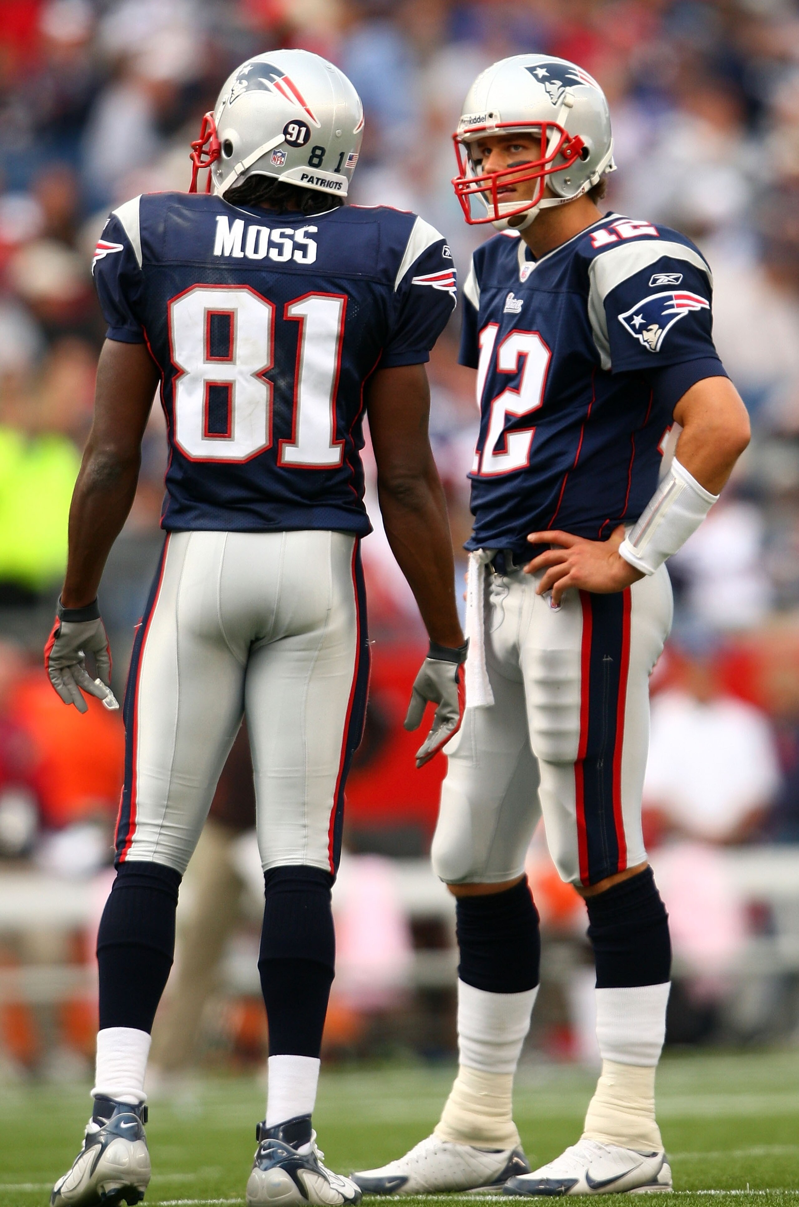 FOXBORO, MA - OCTOBER 07:  Tom Brady #12 and Randy Moss #84 of the New England Patriots talk in between plays in the fourth quarter against the Cleveland Browns on October 7, 2007 at Gillette Stadium in Foxboro, Massachusetts. The Patriots defeated the Br