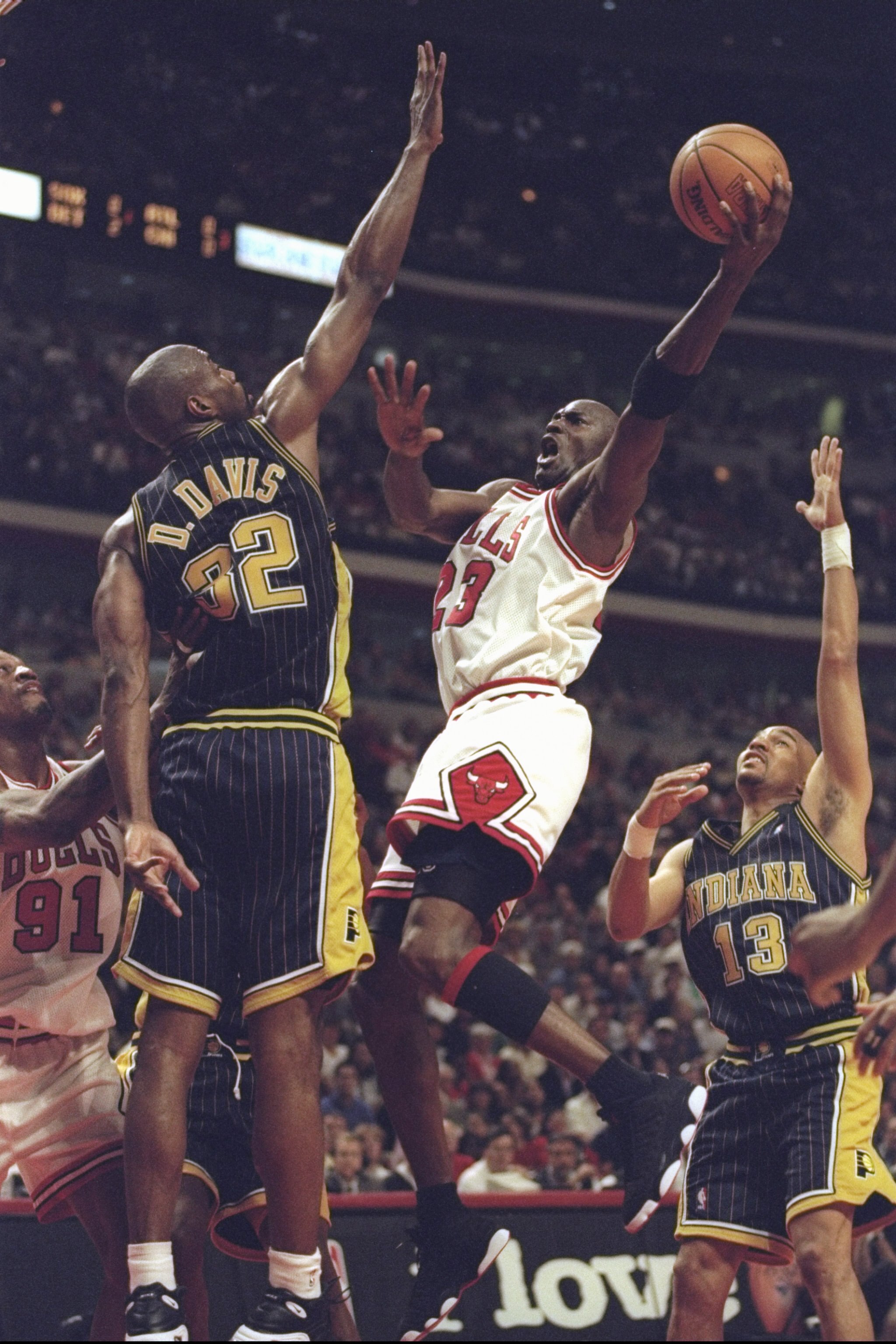 31 May 1998: Michael Jordan #23 of the Chicago Bulls drives to the basket over Dale Davis #32 of the Indiana Pacers during game seven of the Eastern Conference Finals at the United Center in Chicago, Illinois. The Bulls defeated the Pacers 88-83.
