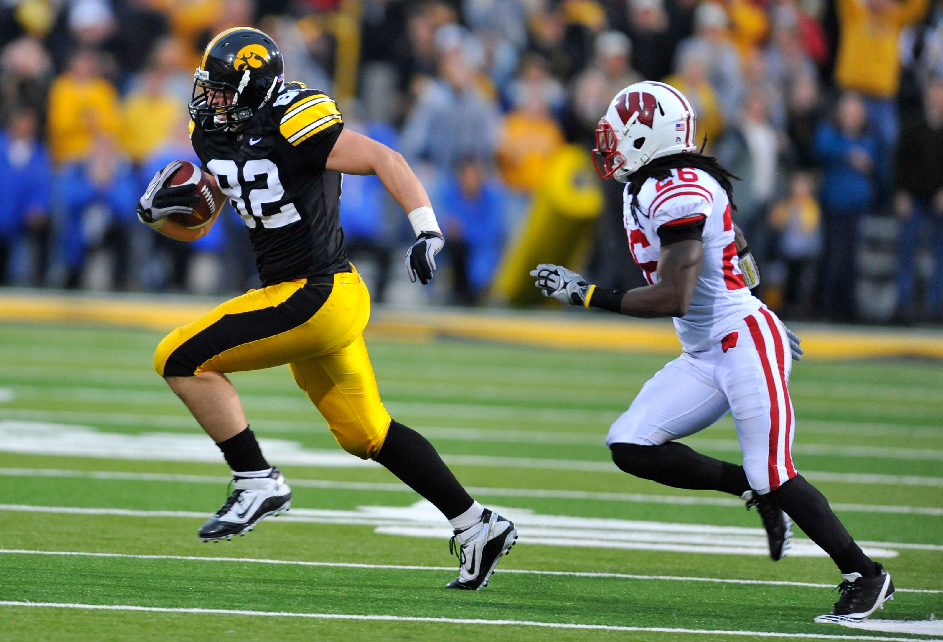 IOWA CITY, IA - OCTOBER 23- Tight end Allen Reisner #82 of the University of Iowa Hawkeyes breaks away from defensive back Antonio Henry #26 of the Wisconsin Badgers during the second half of play at Kinnick Stadium on October 23, 2010 in Iowa City, Iowa.