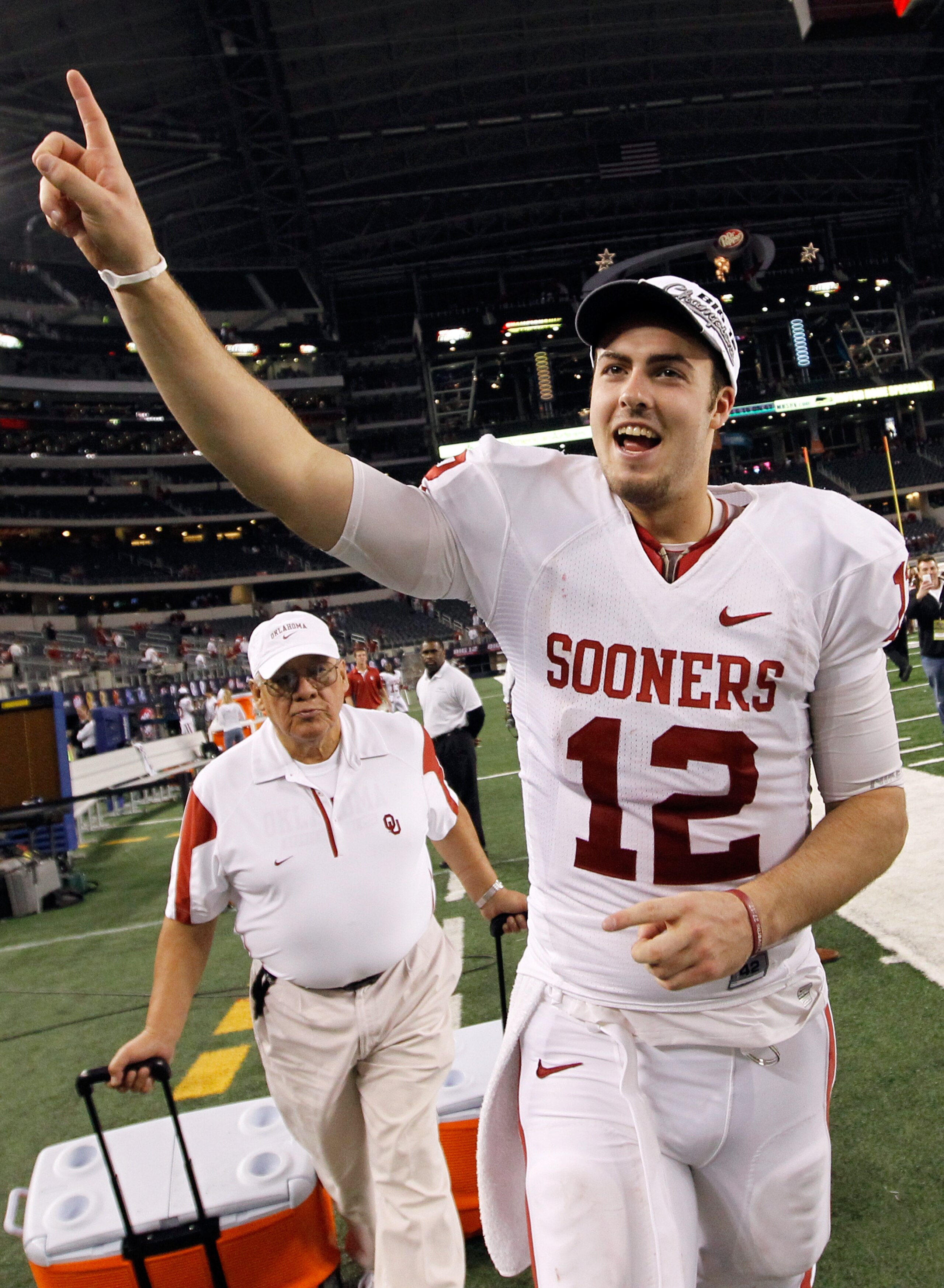 ARLINGTON, TX - DECEMBER 04:  Quarterback Landry Jones #12 of the Oklahoma Sooners celebrates after the Sooners beat the Nebraska Cornhuskers 23-20 at Cowboys Stadium on December 4, 2010 in Arlington, Texas.  (Photo by Tom Pennington/Getty Images)