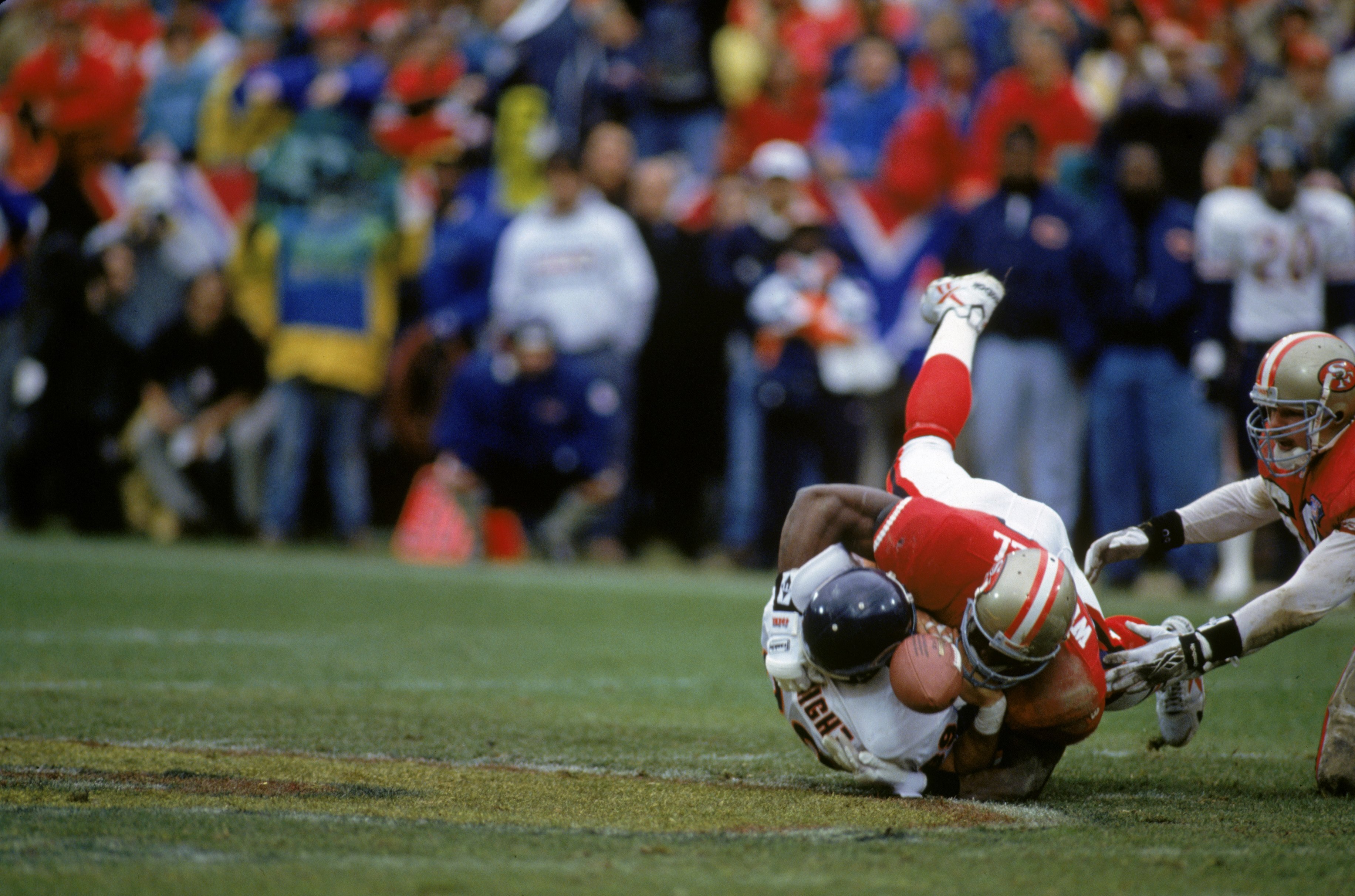 SAN FRANCISCO - JANUARY 7:  Linebacker Lee Woodall #54 of the San Francisco 49ers puts a hit on tight end Ryan Wetnight of the Chicago Bears during the 1994 NFC Divisional Playoff game at Candlestick Park on January 7, 1995 in San Francisco, California.