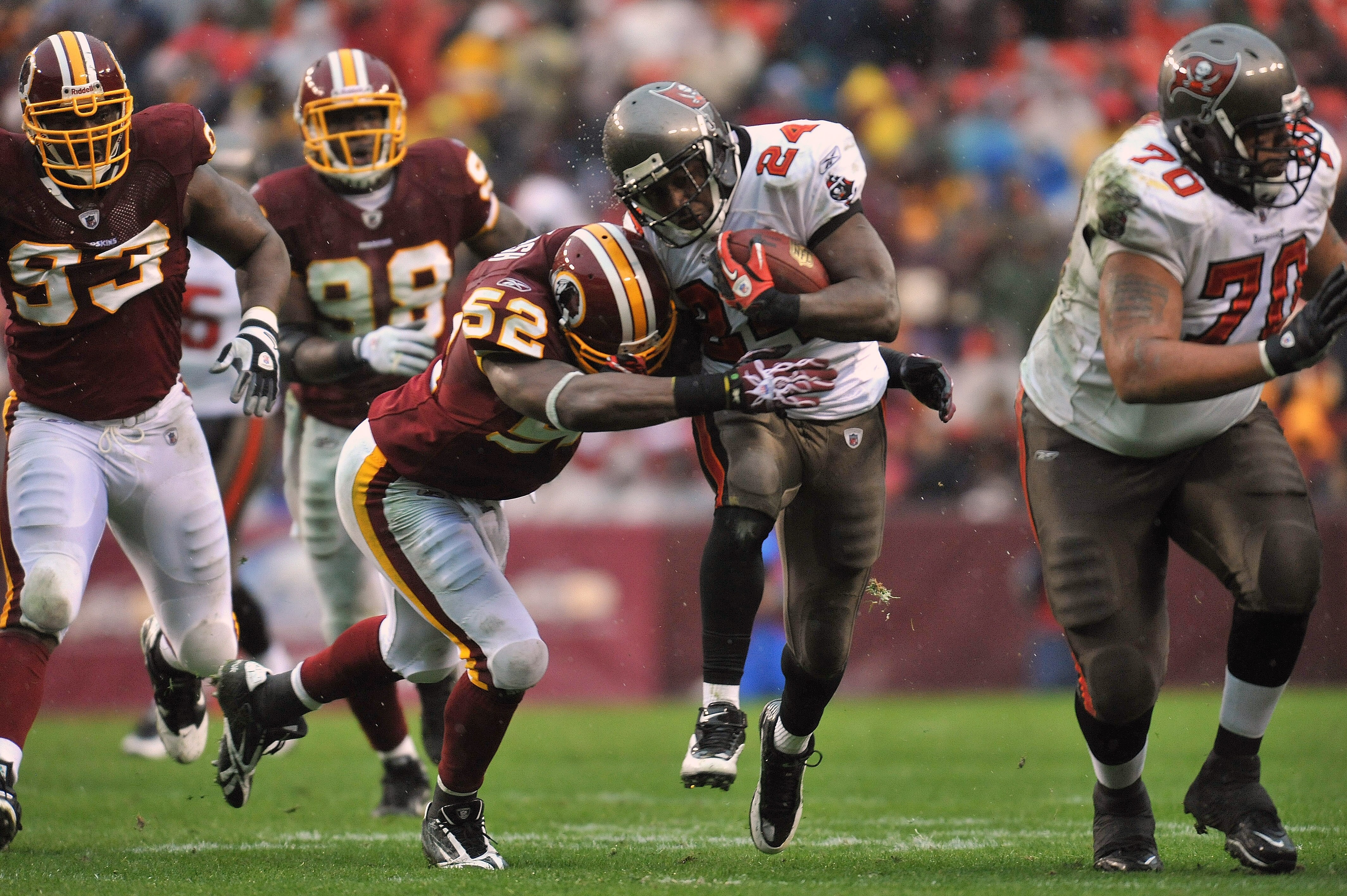 LANDOVER, MD - DECEMBER 12:  Carnell Williams #2 of the Tampa Bay Buccaneers runs the ball while Rocky Mcintosh #52 of the Washington Redskins defends at FedExField on December 12, 2010 in Landover, Maryland. The Buccaneers defeated the Redskins 17-16. (P