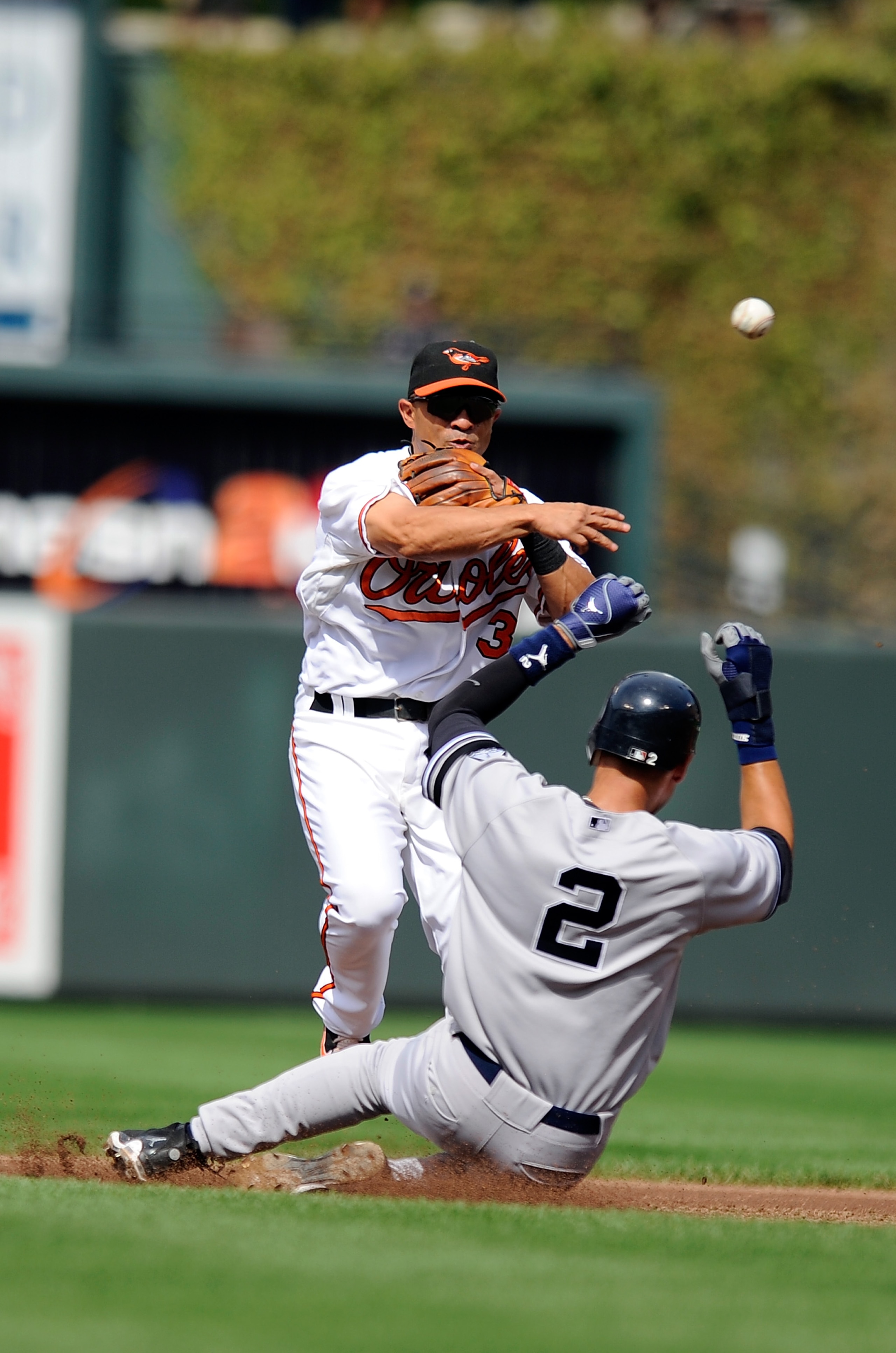 BALTIMORE - SEPTEMBER 19:  Cesar Izturis #3 of the Baltimore Orioles forces out Derek Jeter #2 of the New York Yankees to start a double play at Camden Yards on September 19, 2010 in Baltimore, Maryland.  (Photo by Greg Fiume/Getty Images)