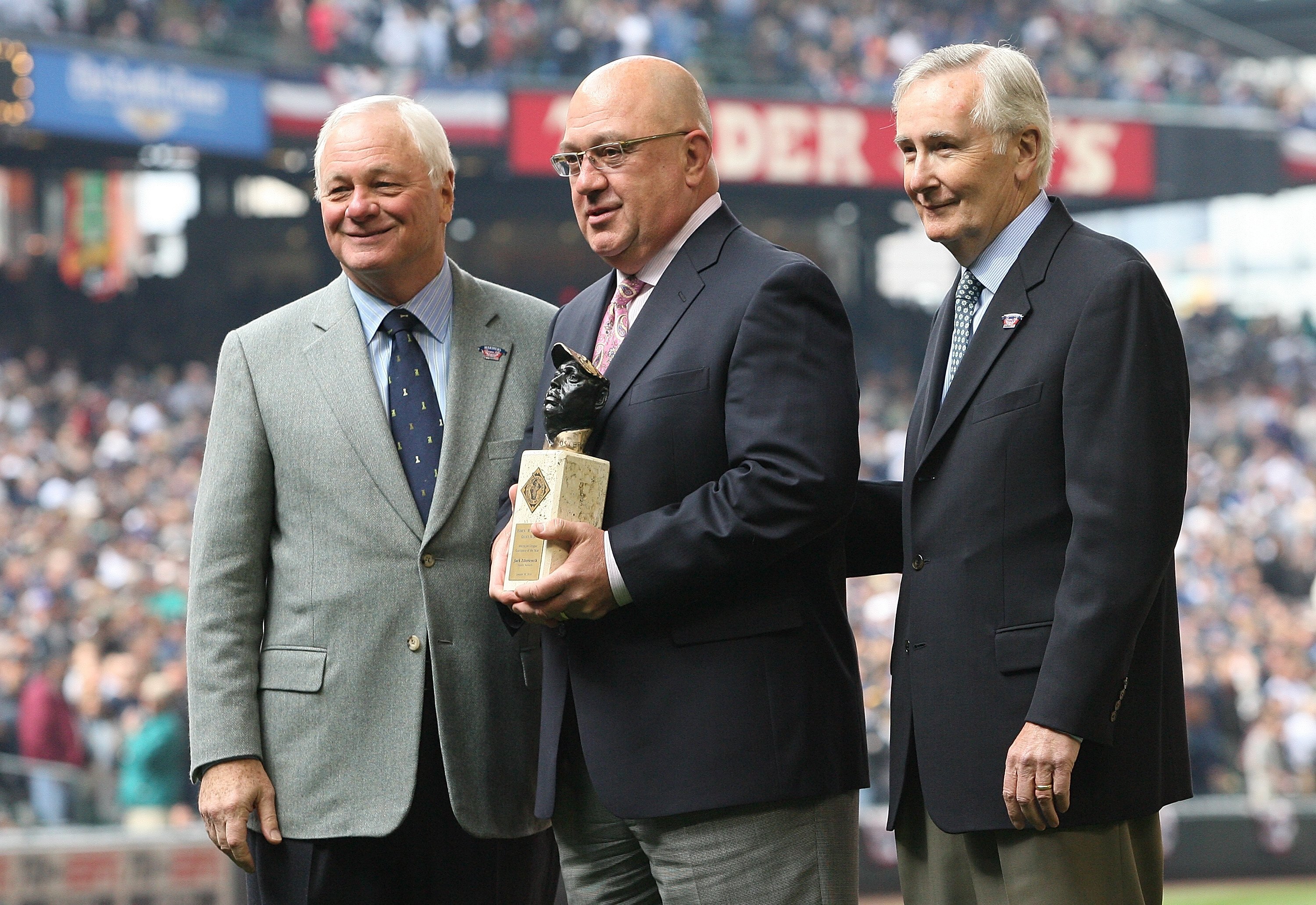 SEATTLE - APRIL 12:  L to R: Team president Chuck Armstrong, general manager Jack Zduriencik, and CEO Howard Lincoln of the Seattle Mariners pose for a photo as Zduriencik is presented with the Negro Leagues Baseball Museum 'Rube' Foster American League E