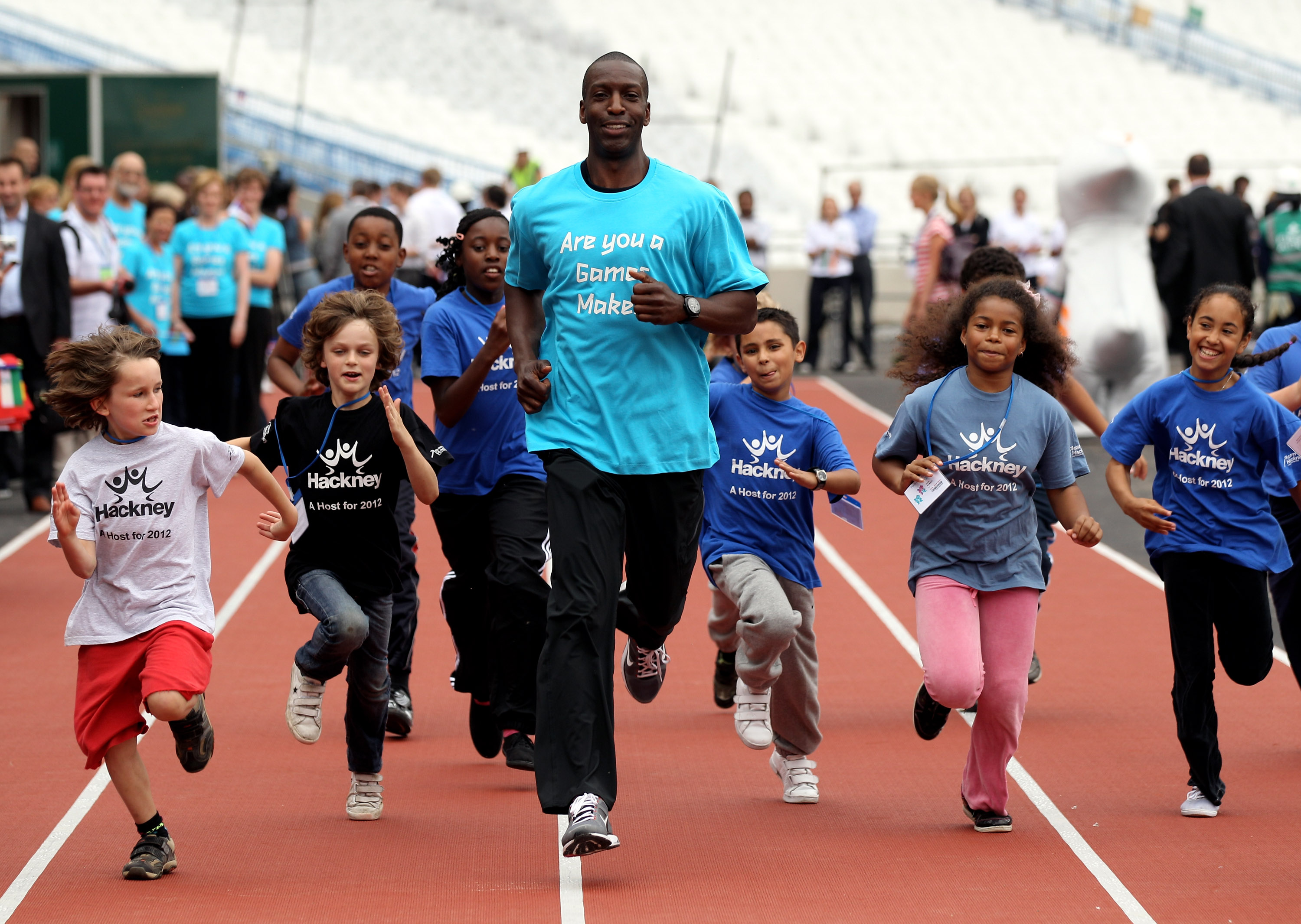 LONDON, ENGLAND - JULY 27:  Michael Johnson (C), a four-time Olympic gold medalist, runs along a track inside the Olympic Stadium in Stratford on July 27, 2010 in London, England. Today marks two years to go until the London Olympic Games in 2012 and the