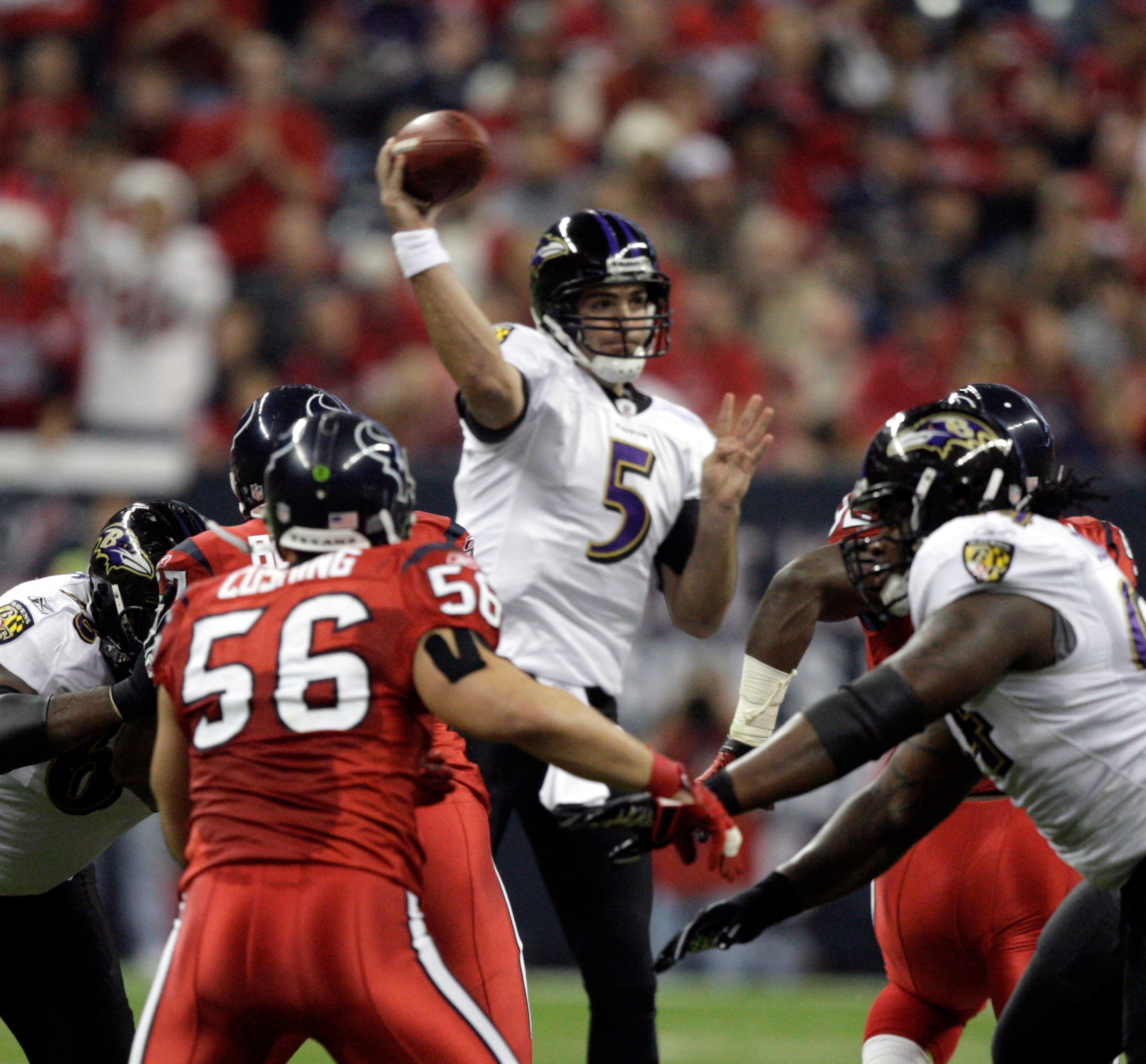 HOUSTON, TX - DECEMBER 13:  Quarterback Joe Flacco #5 of the Baltimore Ravens throws over the Houston Texans defense at Reliant Stadium on December 13, 2010 in Houston, Texas.  (Photo by Bob Levey/Getty Images)