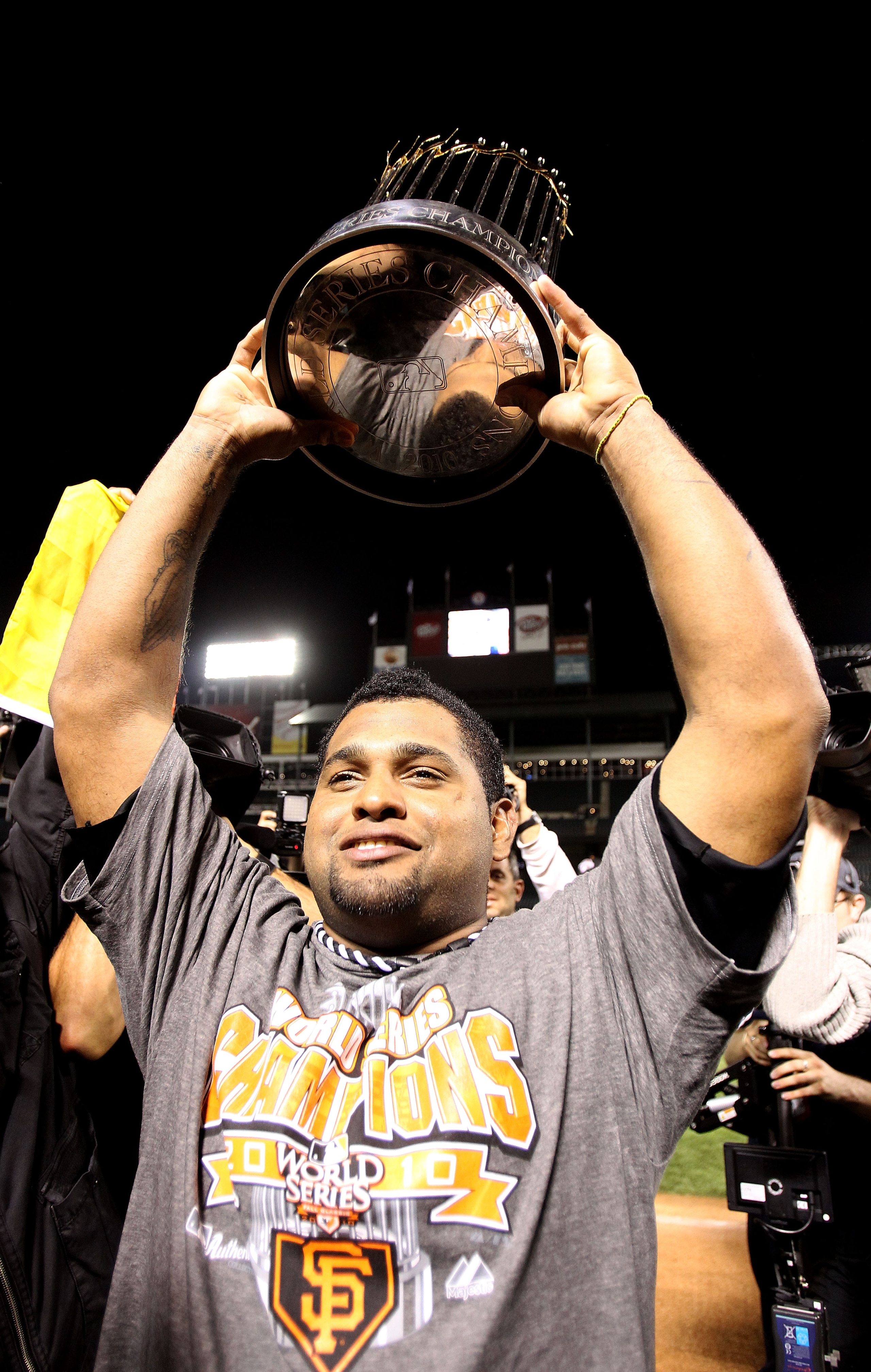 ARLINGTON, TX - NOVEMBER 01:  Pablo Sandovalof the San Francisco Giants celebrates with the World Series Championship trophy after the Giants won 3-1 the Texas Rangers in Game Five of the 2010 MLB World Series at Rangers Ballpark in Arlington on November
