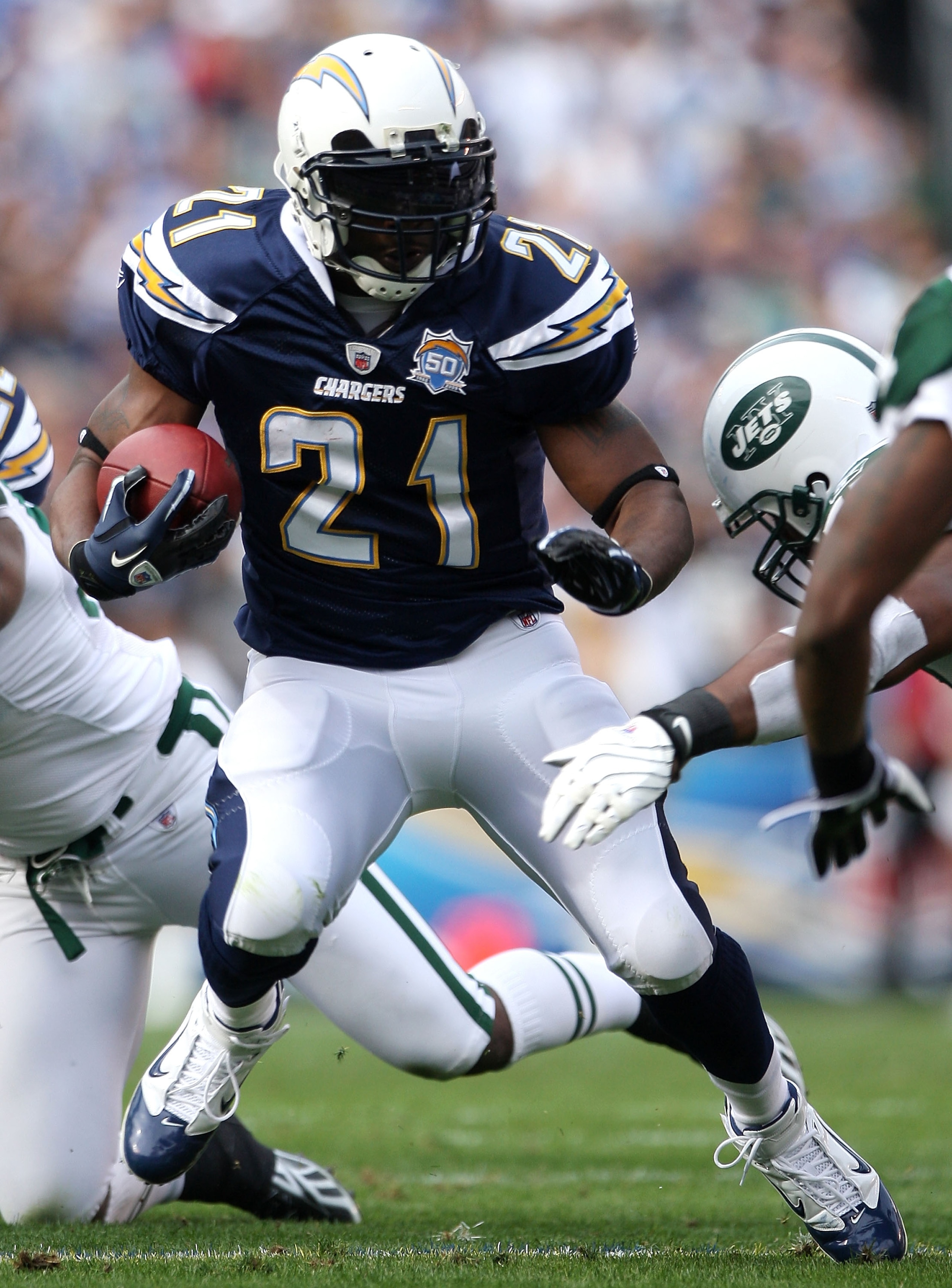 SAN DIEGO - JANUARY 17:  Running back LaDainian Tomlinson #21 of the San Diego Chargers runs with the ball against the New York Jets during the AFC Divisional Playoff Game at Qualcomm Stadium on January 17, 2010 in San Diego, California.  (Photo by Donald