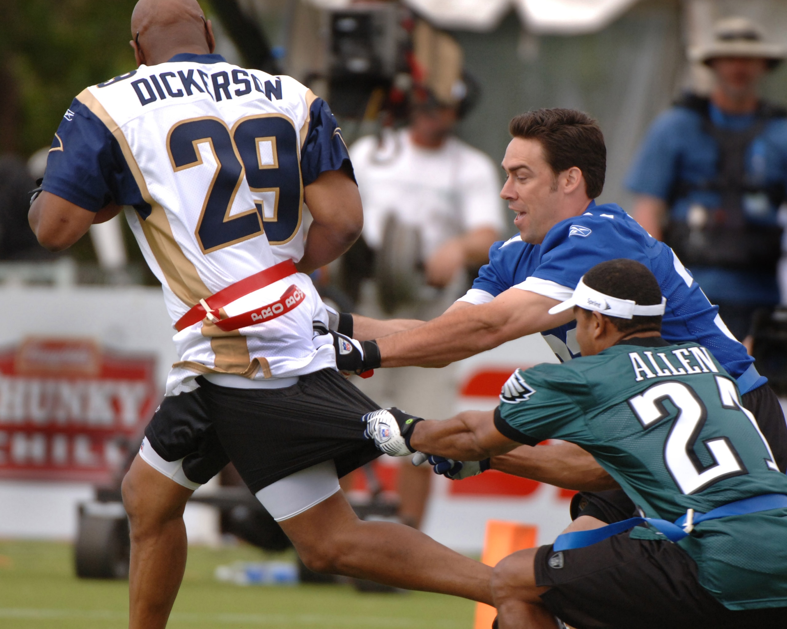 Jason Sehorn and Eric Allen tackle Eric Dickerson  during an alumni air it out flag football game February 10 before  the 2006 Pro Bowl in Honolulu.  (Photo by Al Messerschmidt/Getty Images)