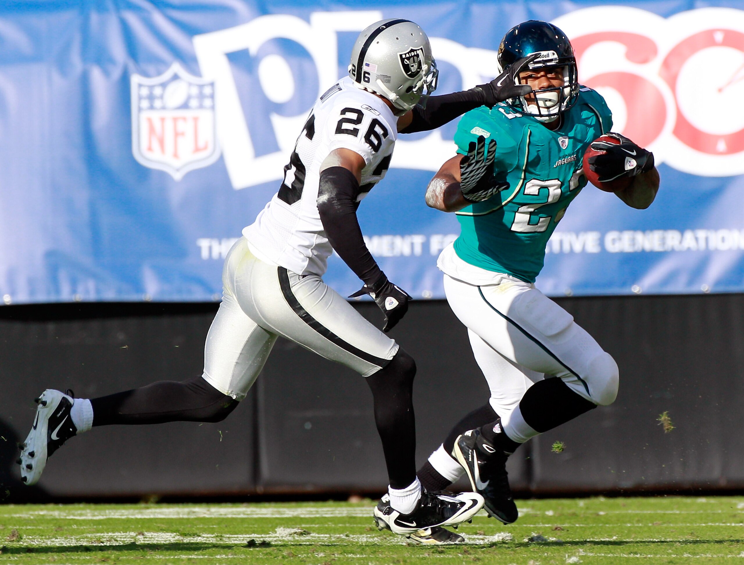 JACKSONVILLE, FL - DECEMBER 12:   Stanford Routt #26 of the Oakland Raiders attempts to tackle Rashad Jennings #23 of the Jacksonville Jaguars during the game at EverBank Field on December 12, 2010 in Jacksonville, Florida.  (Photo by Sam Greenwood/Getty
