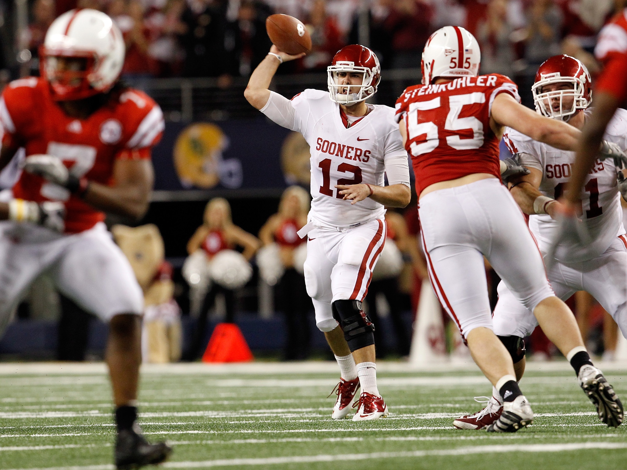 ARLINGTON, TX - DECEMBER 04:  Quarterback Landry Jones #12 of the Oklahoma Sooners looks for an open receiver against the Nebraska Cornhuskers at Cowboys Stadium on December 4, 2010 in Arlington, Texas.  The Sooners beat the Cornhuskers 23-20.  (Photo by