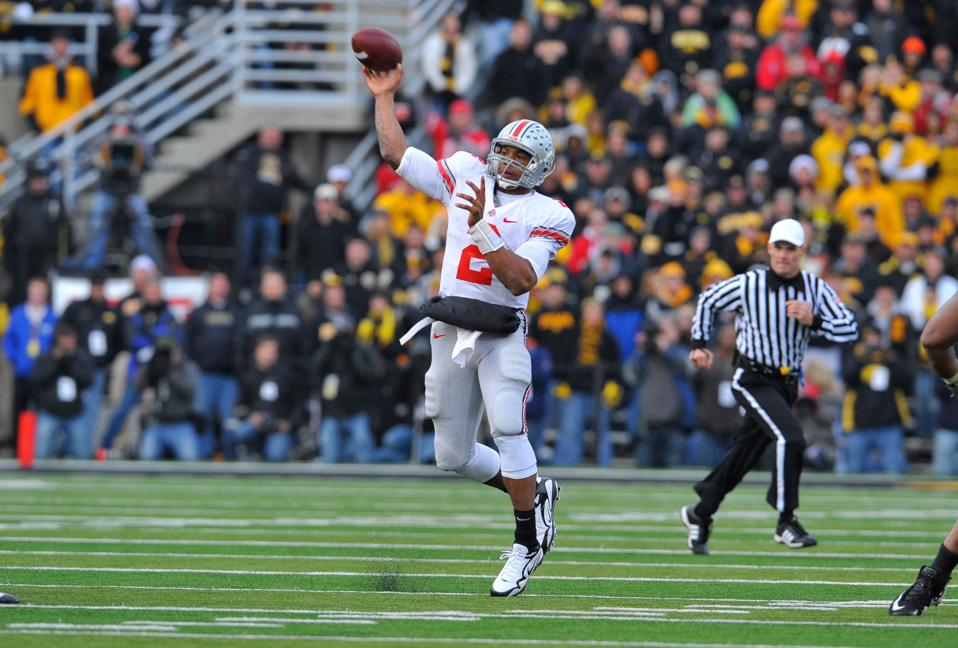 IOWA CITY, IA - NOVEMBER 20:  Quarterback Terrelle Pryor #2 of the Ohio State Buckeyes throws under pressure from University of Iowa Hawkeyes defenders during the second half of play at Kinnick Stadium on November 20, 2010 in Iowa City, Iowa. Ohio State w