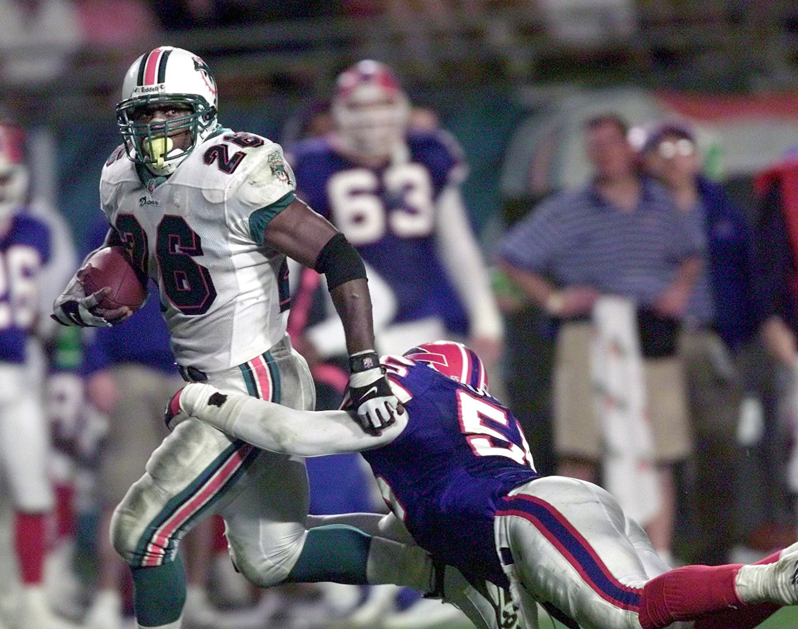 6 Jan 2002: Lamar Smith # 26 of the Miami Dolphins gets away from Jay Foreman # 55 of the Buffalo Bills in the fourth quarter at Pro Player Stadium in Miami Florida. Dolphins won 34-7. DIGITAL IMAGE. Mandatory Credit: Eliot Schechter/Getty Images