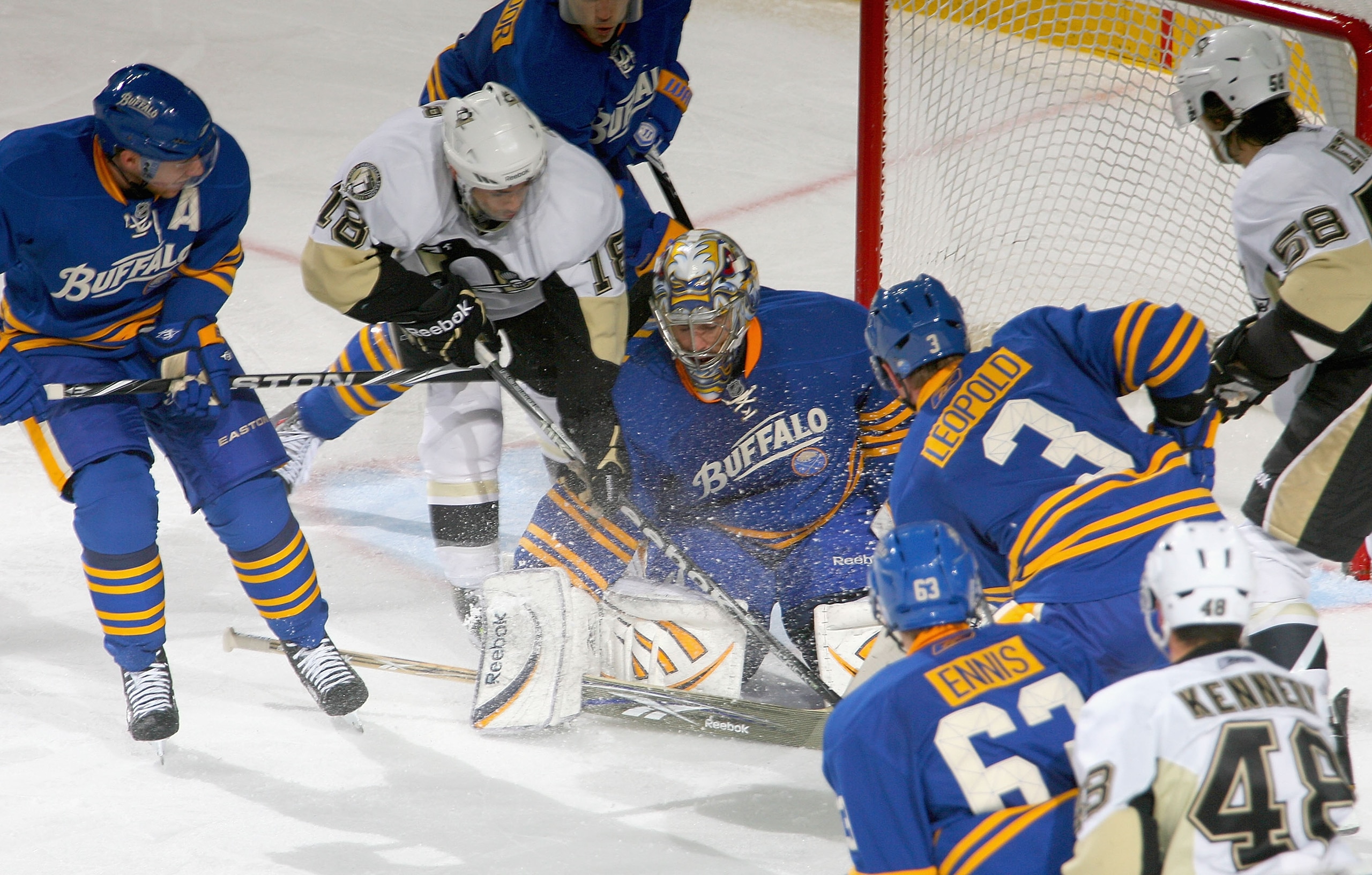 BUFFALO, NY - DECEMBER 11: Ryan Miller #30  of the Buffalo Sabres deflects the puck away from Chris Conner #18 of the Pittsburgh Penguins at HSBC Arena on December 11, 2010 in Buffalo, New York.  (Photo by Rick Stewart/Getty Images)