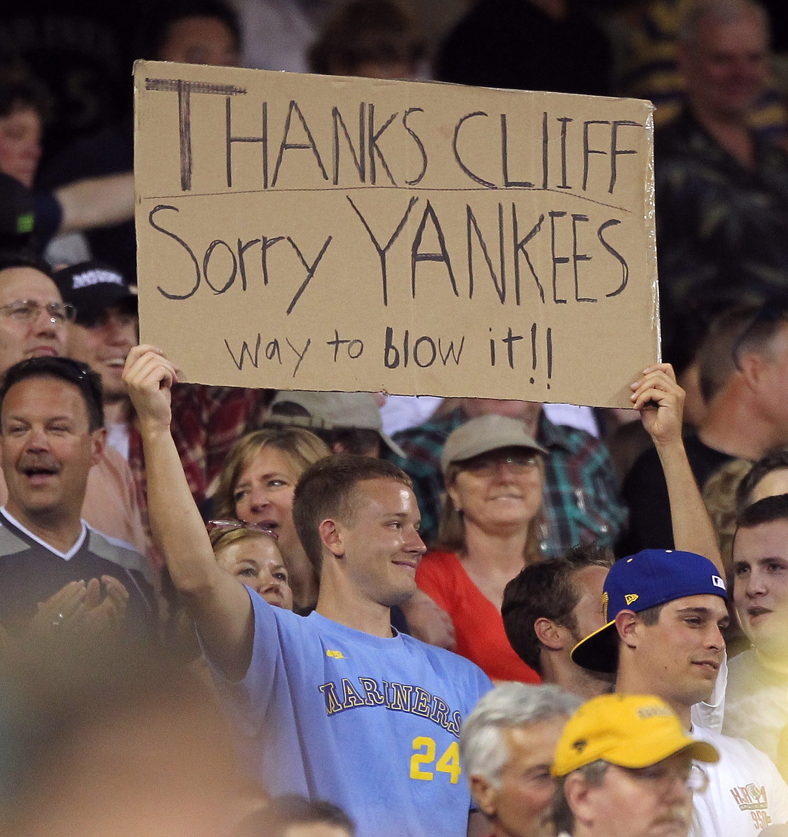 SEATTLE - JULY 09:  A fan holds a sign referring to a trade earlier in the day of starting pitcher Cliff Lee and Mark Lowe from the Seattle Mariners to the Texas Rangers in exchange for first baseman Justin Smoak, pitcher Blake Beavan, Double-A Frisco rel