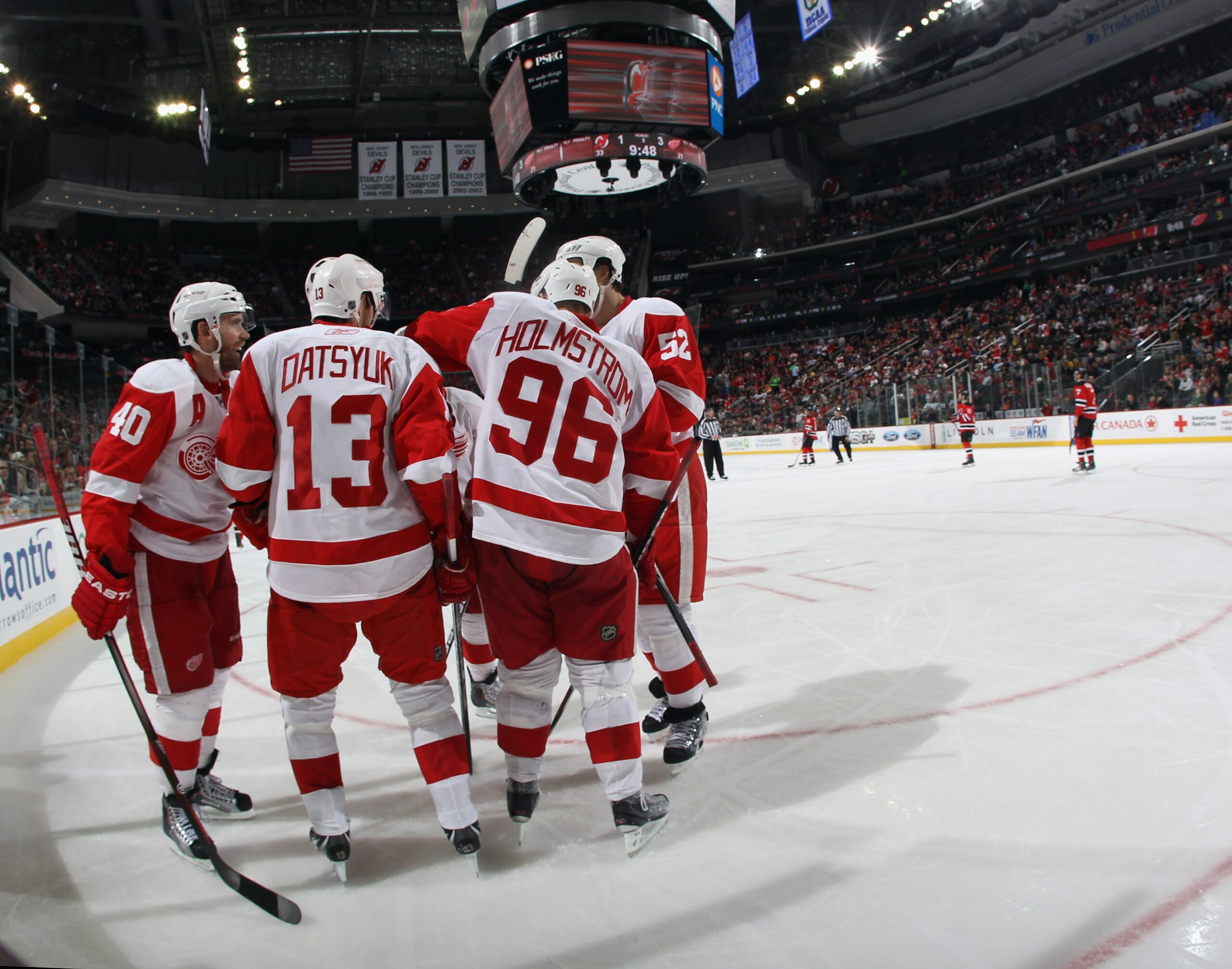 NEWARK, NJ - DECEMBER 11:  Pavel Datsyuk #13 of the Detroit Red Wings is congratulated by Tomas Holmstrom #96 on his goal at 10:26 of the third period against the New Jersey Devils at the Prudential Center on December 11, 2010 in Newark, New Jersey. The R