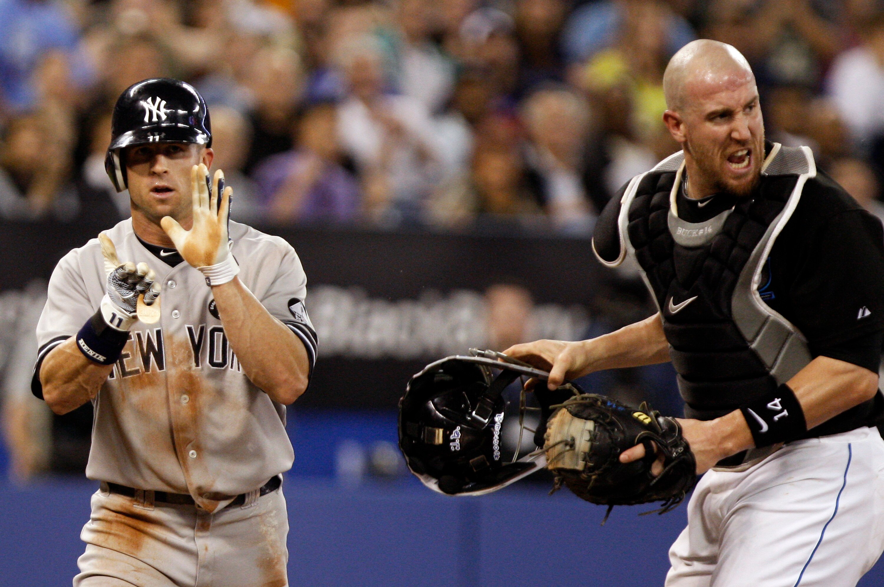 TORONTO, ON - SEPTEMBER 28: John Buck #14 of the Toronto Blue Jays reacts as Brett Gardner #11 of the New York Yankees is called safe at home during an MLB game at the Rogers Centre September 28, 2010 in Toronto, Ontario, Canada. (Photo by Abelimages/Gett