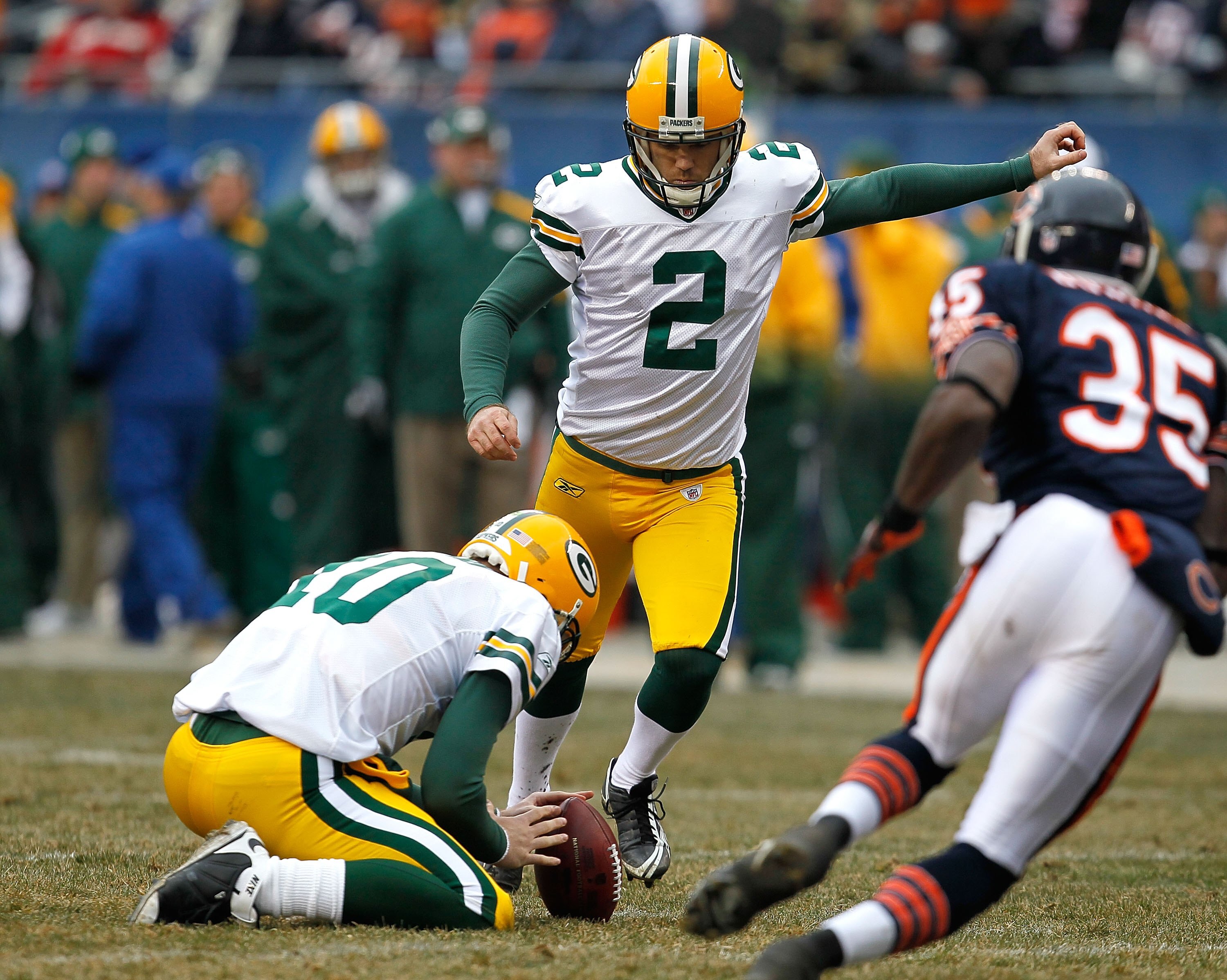 CHICAGO - DECEMBER 13: Mason Crosby #2 of the Green Bay Packers kicks an extra point out of the hold of Matt Flynn #10 against the Chicago Bears at Soldier Field on December 13, 2009 in Chicago, Illinois. The Packers defeated the Bears 21-14. (Photo by Jo