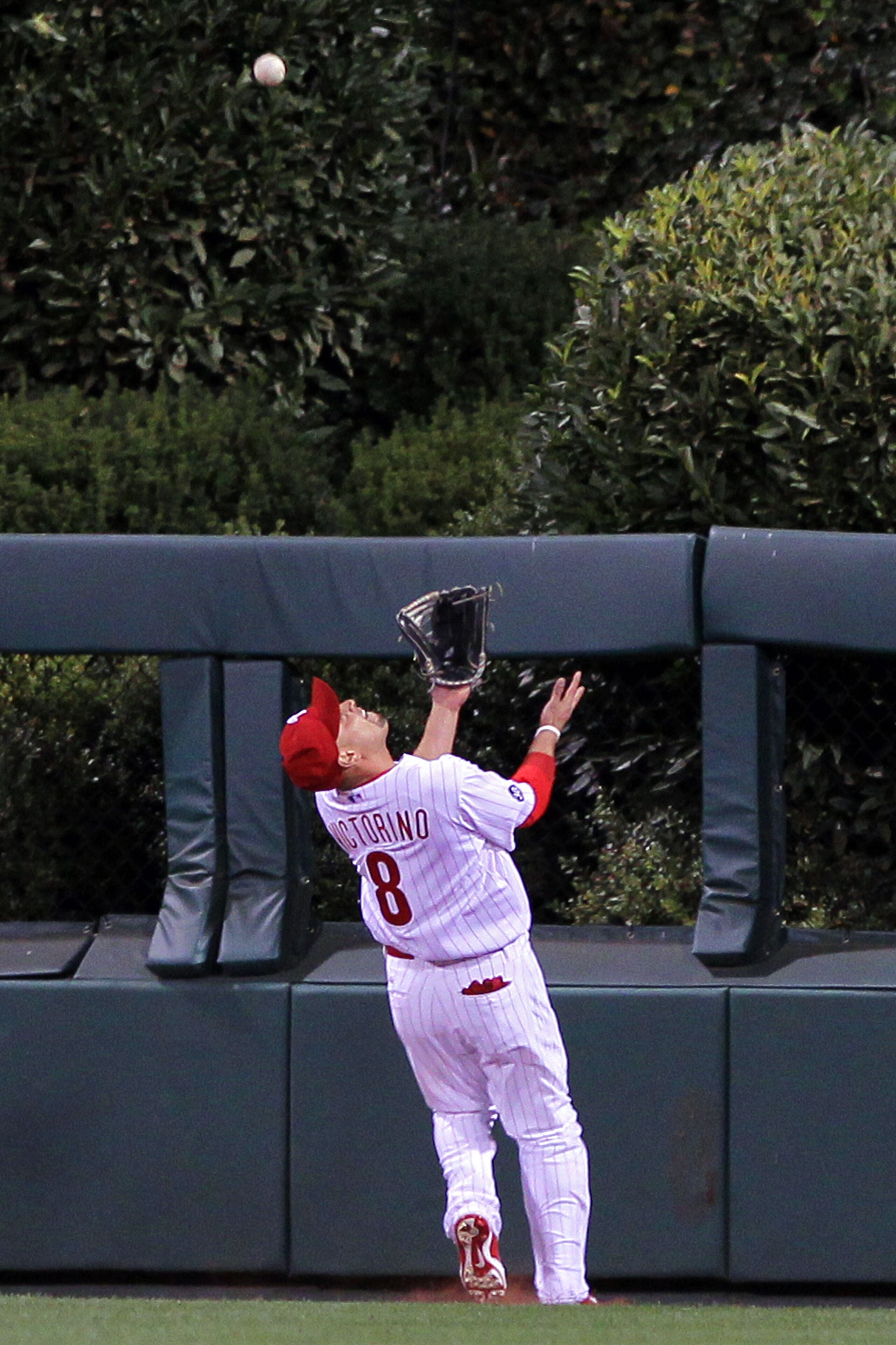 PHILADELPHIA - OCTOBER 23:  Shane Victorino #8 of the Philadelphia Phillies chases down a fly ball in centerfiled against the San Francisco Giants in Game Six of the NLCS during the 2010 MLB Playoffs at Citizens Bank Park on October 23, 2010 in Philadelph