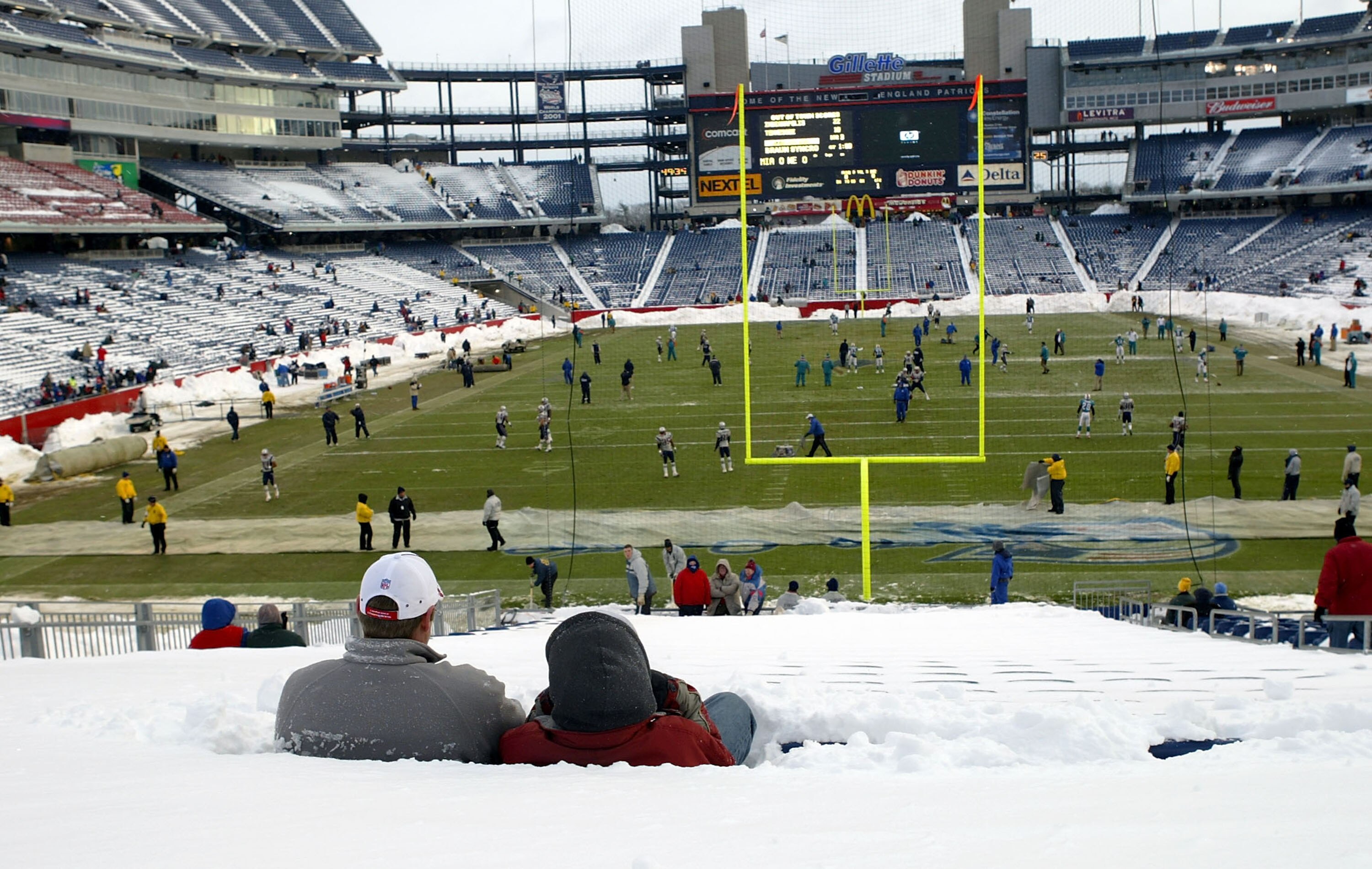FOXBORO, MA - DECEMBER 7:  Fans sit in snow-covered seats before the Miami Dolphins game against the New England Patriots on December 7, 2003 at Gillette Stadium in Foxboro, Massachusetts.  (Photo by Ezra Shaw/Getty Images)