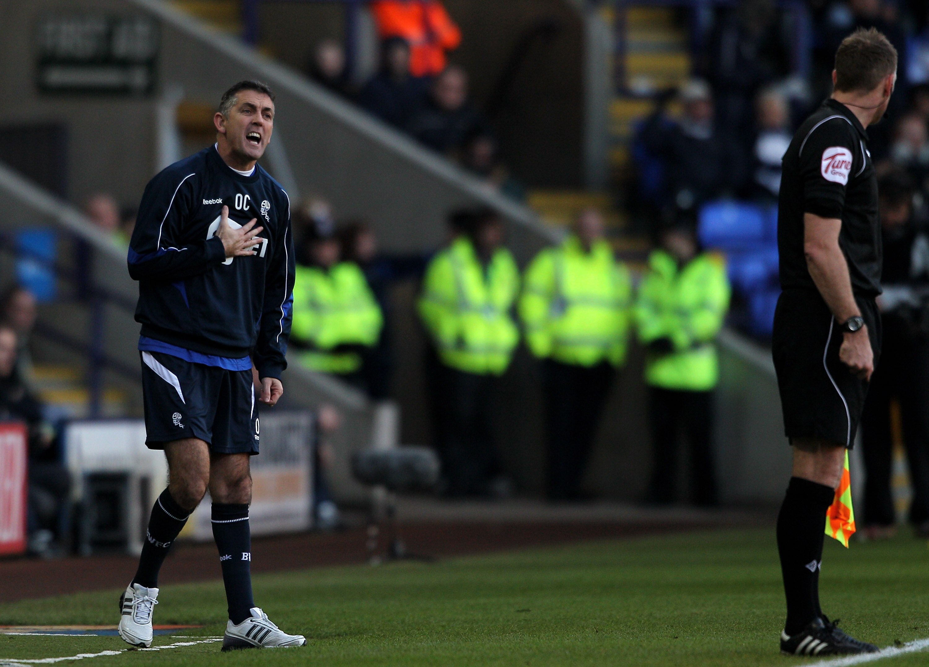 BOLTON, ENGLAND - DECEMBER 12:  Bolton Wanderers Manager Owen Coyle makes a point to the Assistant Referee during the Barclays Premier League match between Bolton Wanderers and Blackburn Rovers at the Reebok Stadium on December 12, 2010 in Bolton, England
