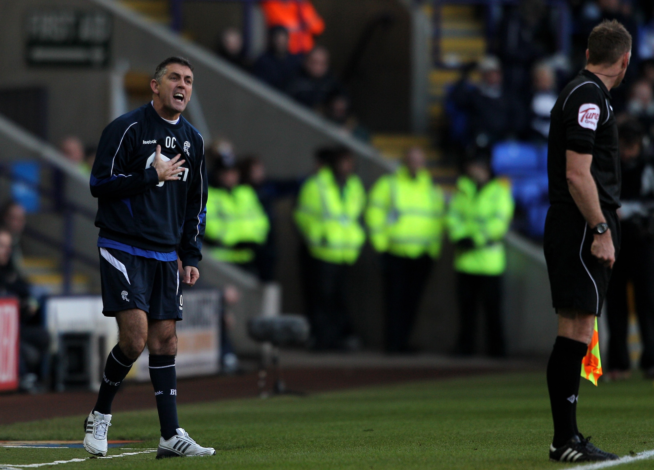 BOLTON, ENGLAND - DECEMBER 12:  Bolton Wanderers Manager Owen Coyle makes a point to the Assistant Referee during the Barclays Premier League match between Bolton Wanderers and Blackburn Rovers at the Reebok Stadium on December 12, 2010 in Bolton, England