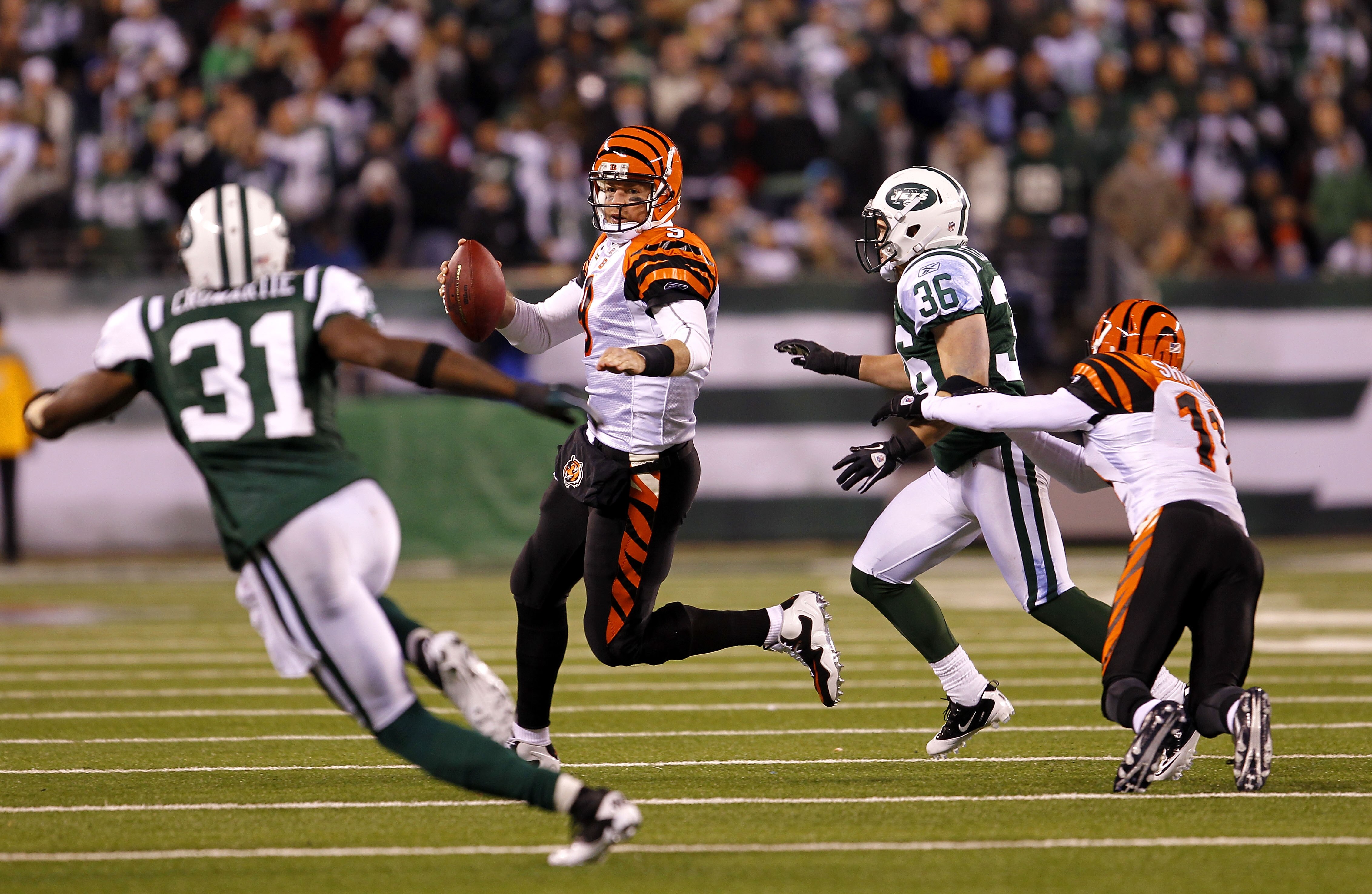 EAST RUTHERFORD, NJ - NOVEMBER 25:  Quarterback Carson Palmer #9 of the Cincinnati Bengals throws a pass under pressure from Jim Leonhard #36 of the New York Jets at New Meadowlands Stadium on November 25, 2010 in East Rutherford, New Jersey. The Jets def