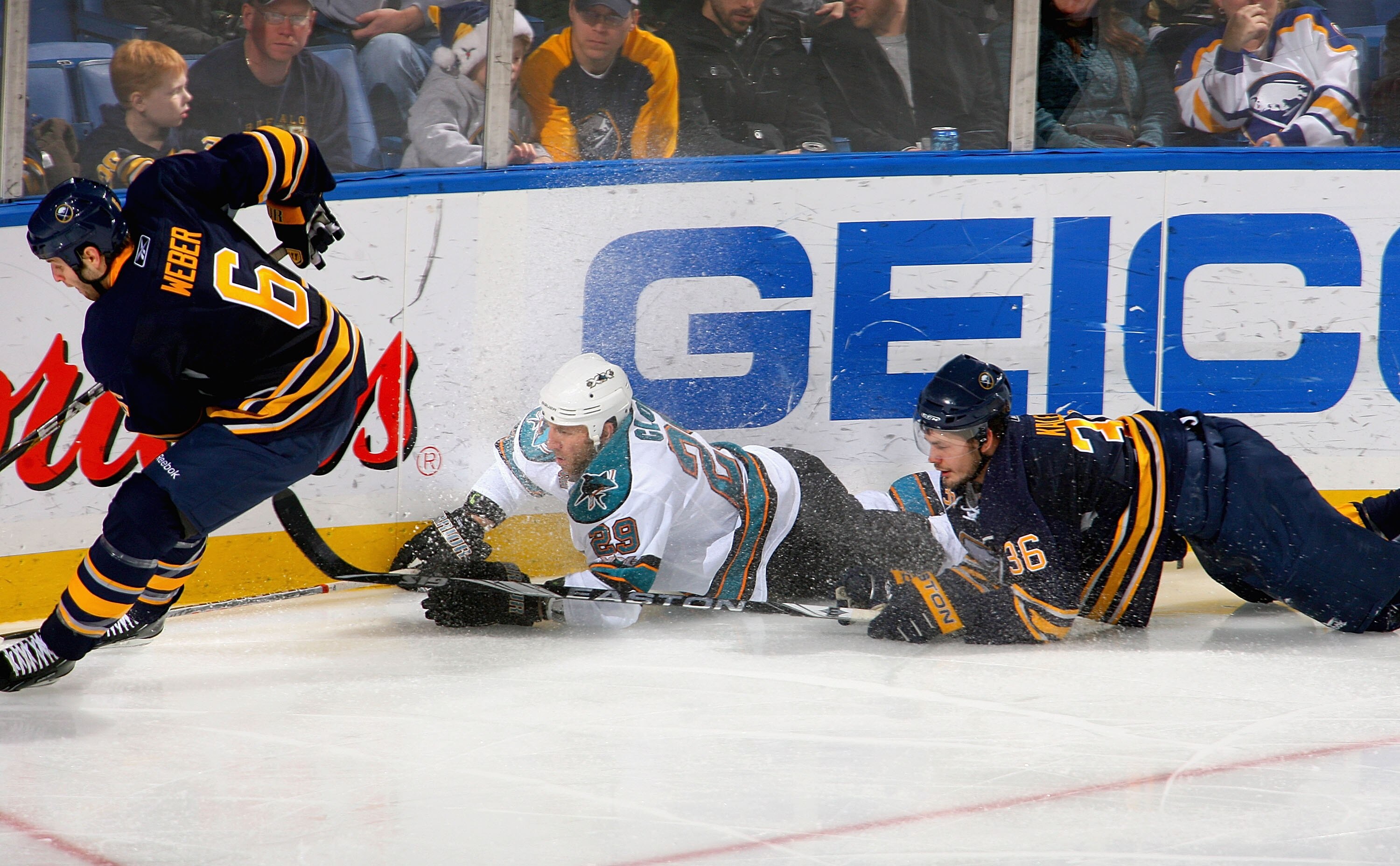 BUFFALO, NY - DECEMBER 09: Ryane Clowe #29 of the San Jose Sharks and Patrick Kaleta #36 of the   Buffalo Sabres fall behind Mike Weber #6 of the Sabres  at HSBC Arena on December 9, 2010 in Buffalo, New York.  (Photo by Rick Stewart/Getty Images)