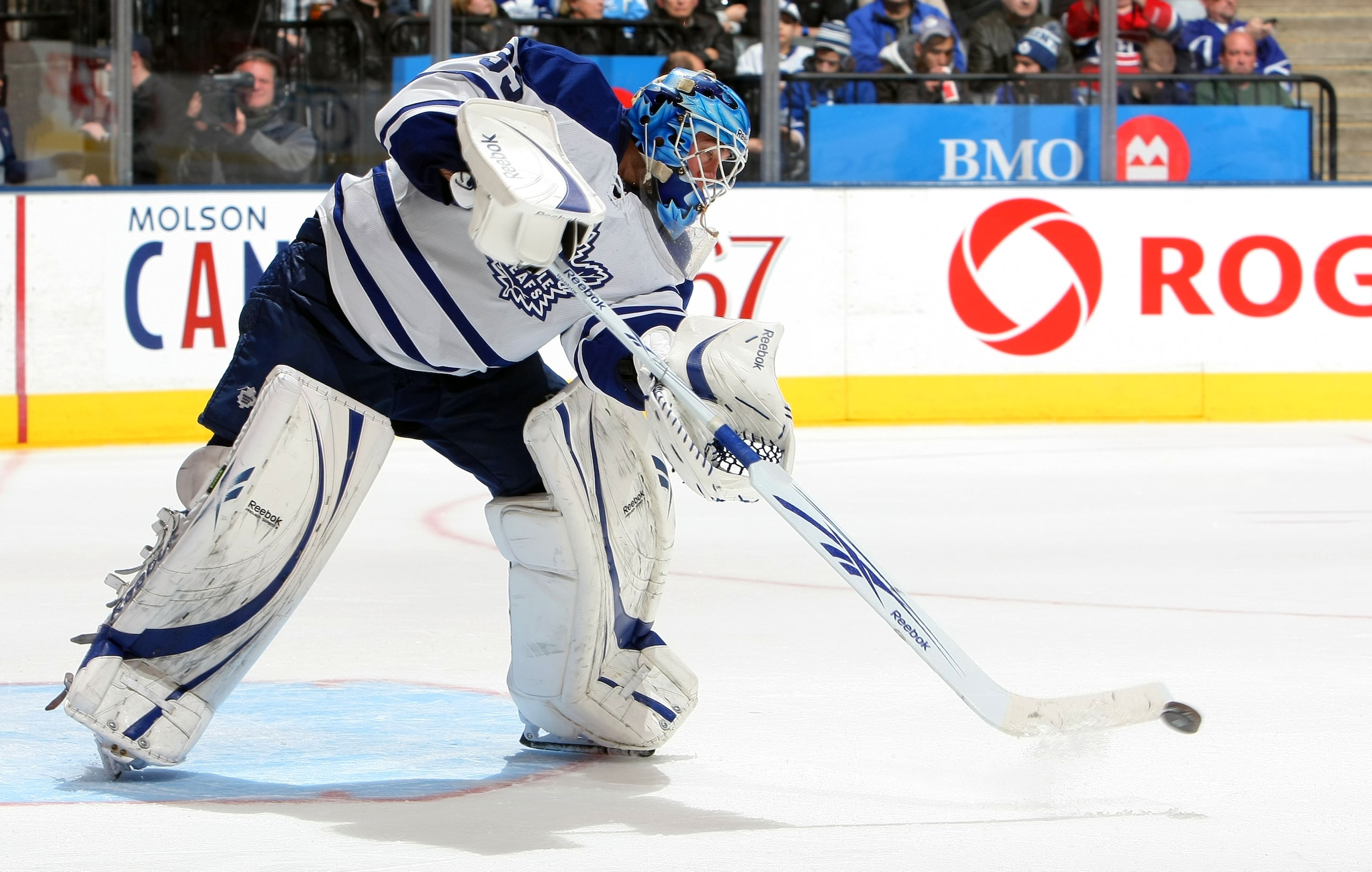 TORONTO - DECEMBER 11:  Jean-Sebastien Giguere #35 of the Toronto Maple Leafs clears the puck against the Montreal Canadiens during their NHL game at Air Canada Centre on December 11, 2010 in Toronto, Ontario, Canada.(Photo By Dave Sandford/Getty Images)