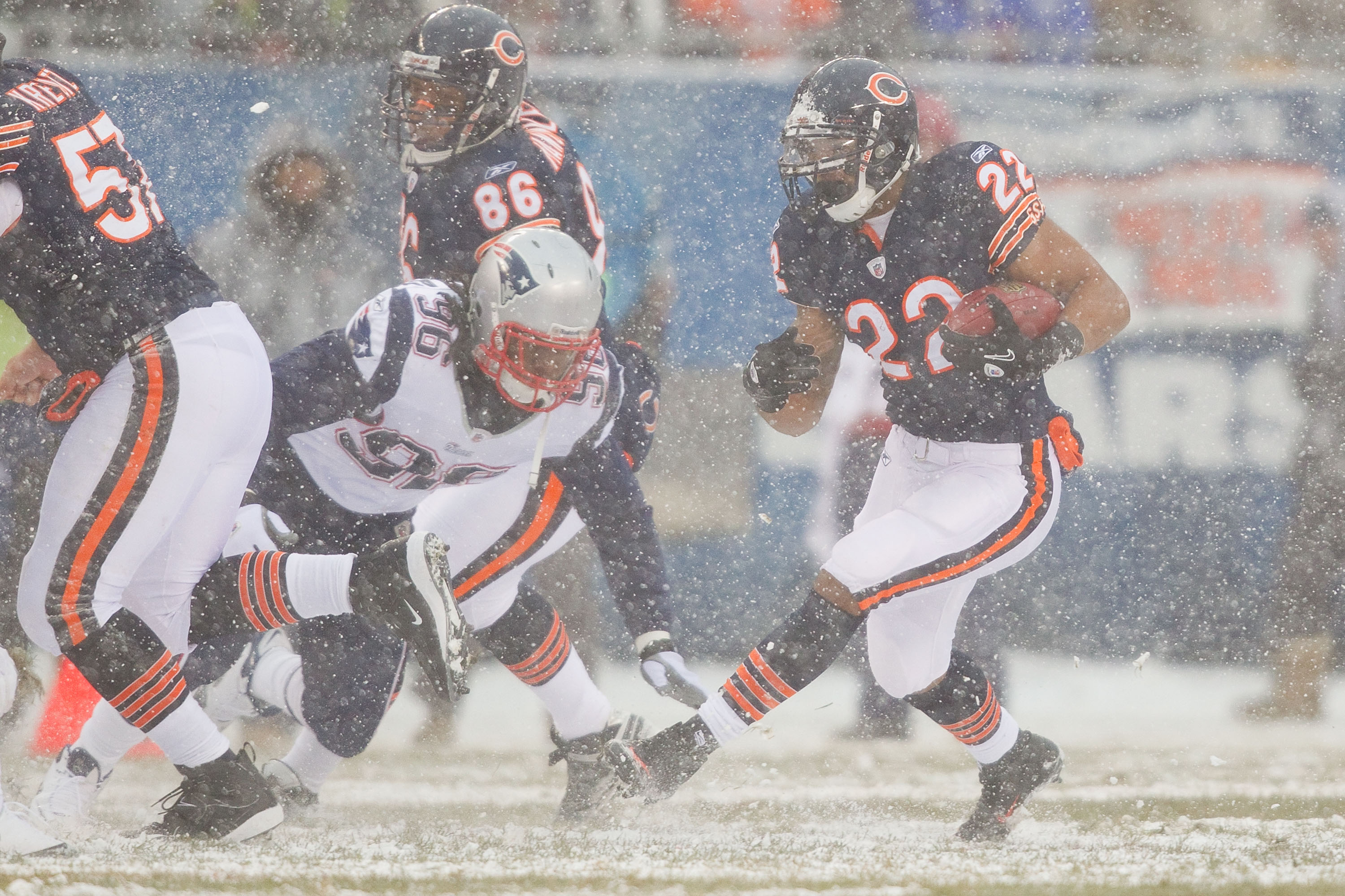 CHICAGO, IL - DECEMBER 12: Matt Forte #22 of the Chicago Bears looks to get past Jermaine Cunningham #96 of the New England Patriots at Soldier Field on December 12, 2010 in Chicago, Illinois.  The Patriots beat the Bears 36-7.  (Photo by Dilip Vishwanat/