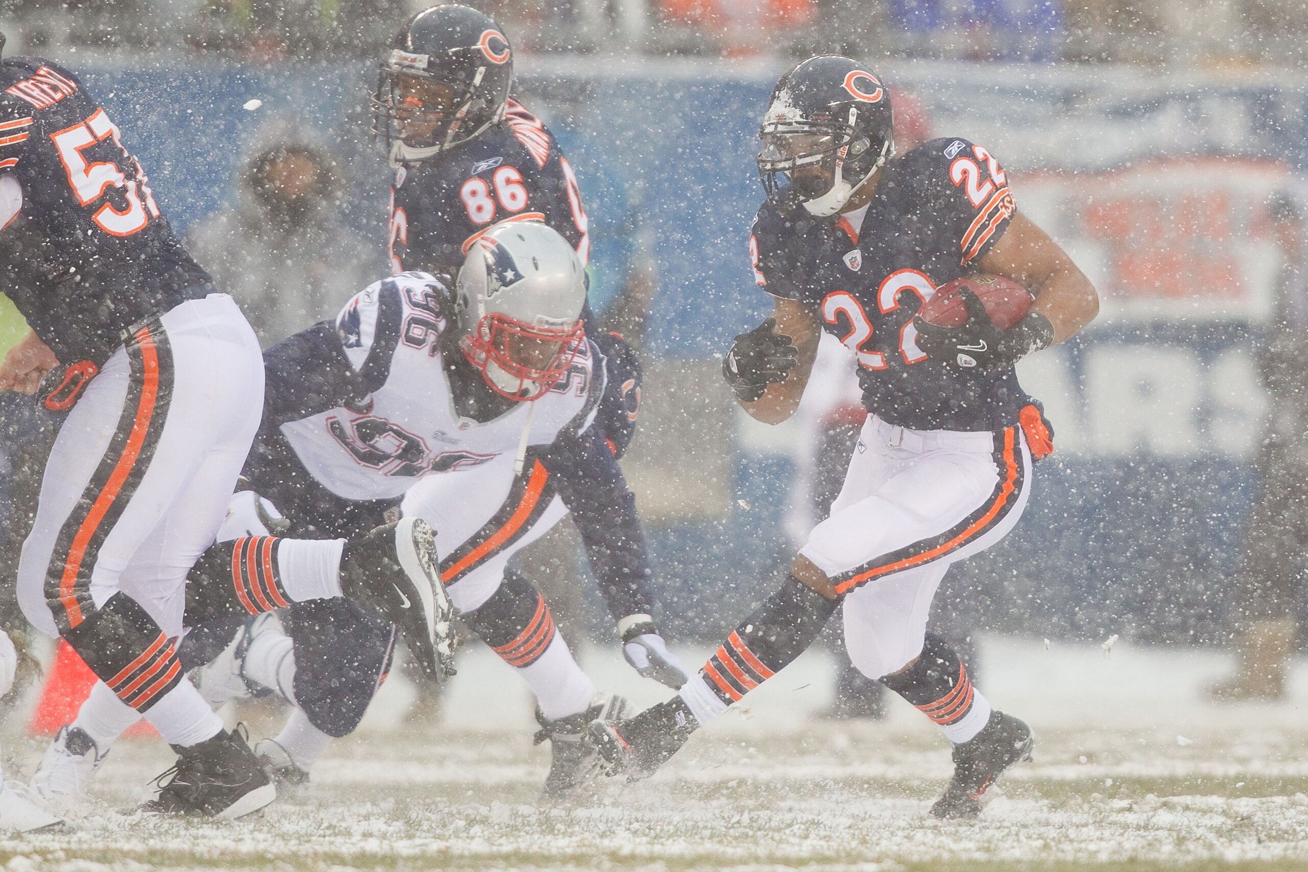 CHICAGO, IL - DECEMBER 12: Matt Forte #22 of the Chicago Bears looks to get past Jermaine Cunningham #96 of the New England Patriots at Soldier Field on December 12, 2010 in Chicago, Illinois.  The Patriots beat the Bears 36-7.  (Photo by Dilip Vishwanat/