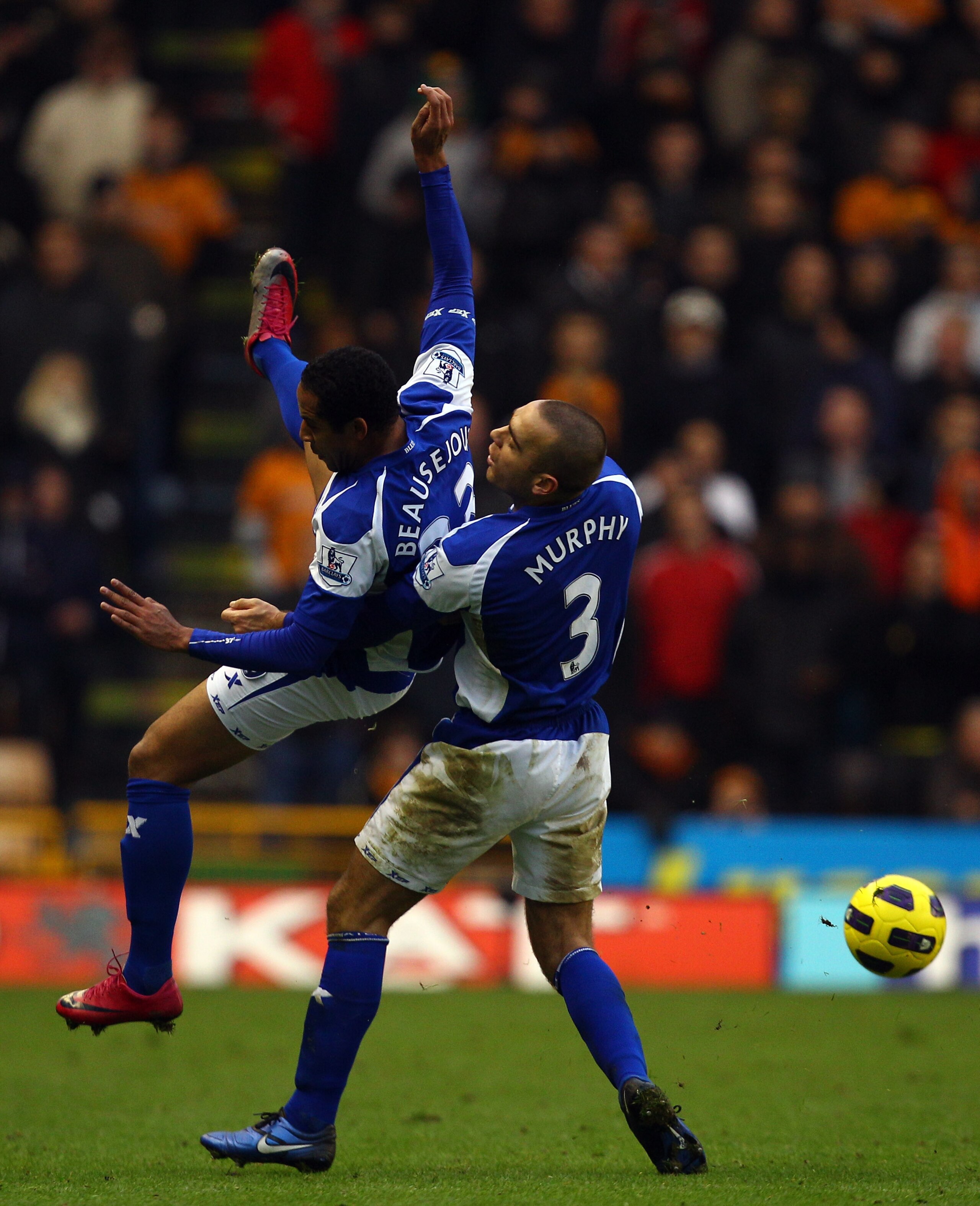 WOLVERHAMPTON, ENGLAND - DECEMBER 12:  Jean Beausejour and David Murphy of Birmingham tackle each other during the Barclays Premier League match between Wolverhampton Wanderers and Birmingham City at Molineux on December 12, 2010 in Wolverhampton, England