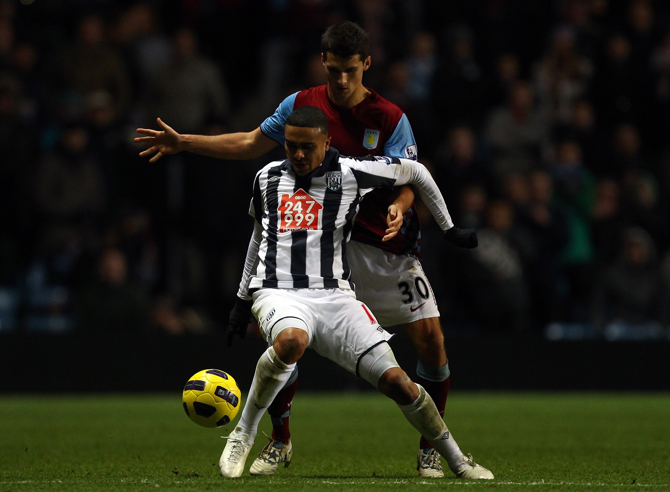 BIRMINGHAM, ENGLAND - DECEMBER 11:  Jerome Thomas of West Brom battles with Eric Lichaj of Villa during the Barclays Premier League match between Aston Villa and West Bromwich Albion at Villa Park on December 11, 2010 in Birmingham, England.  (Photo by Ri